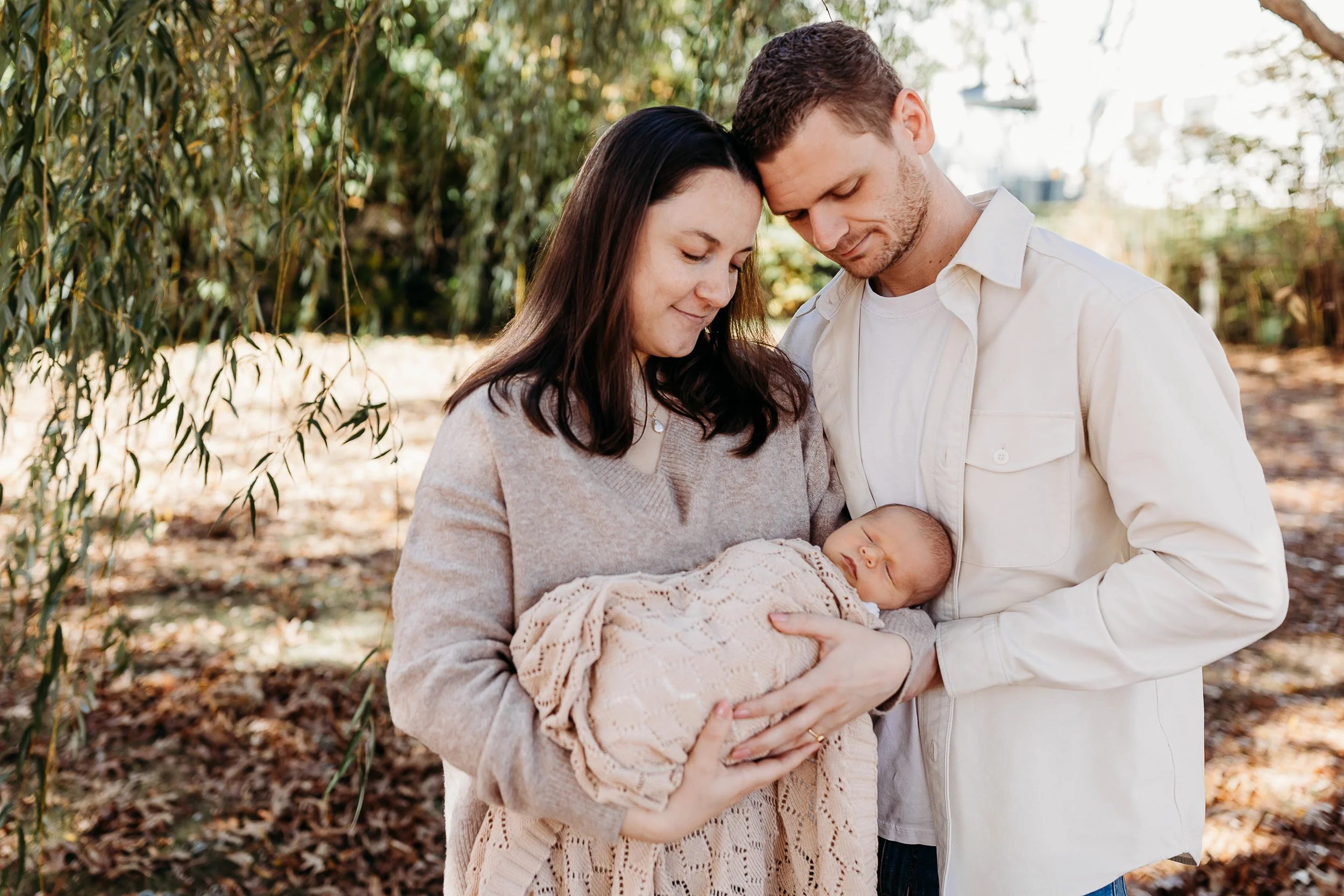 Parents holding newborn together natural candid newborn photography Atlantic Beach Florida