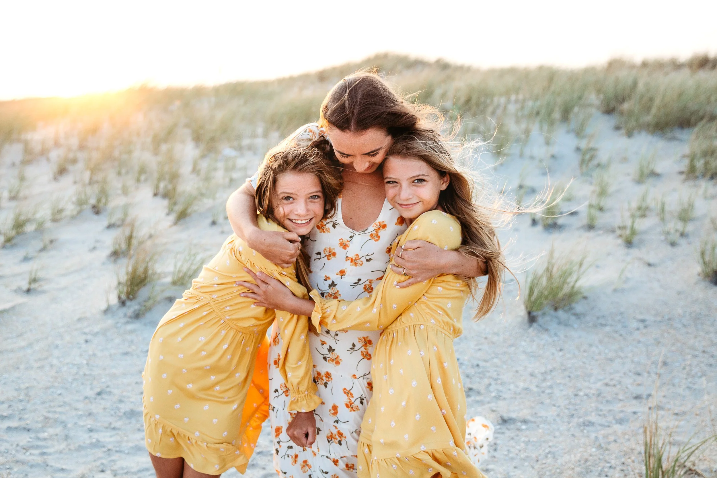 sisters embraced at sunset on a dune in st augustine
