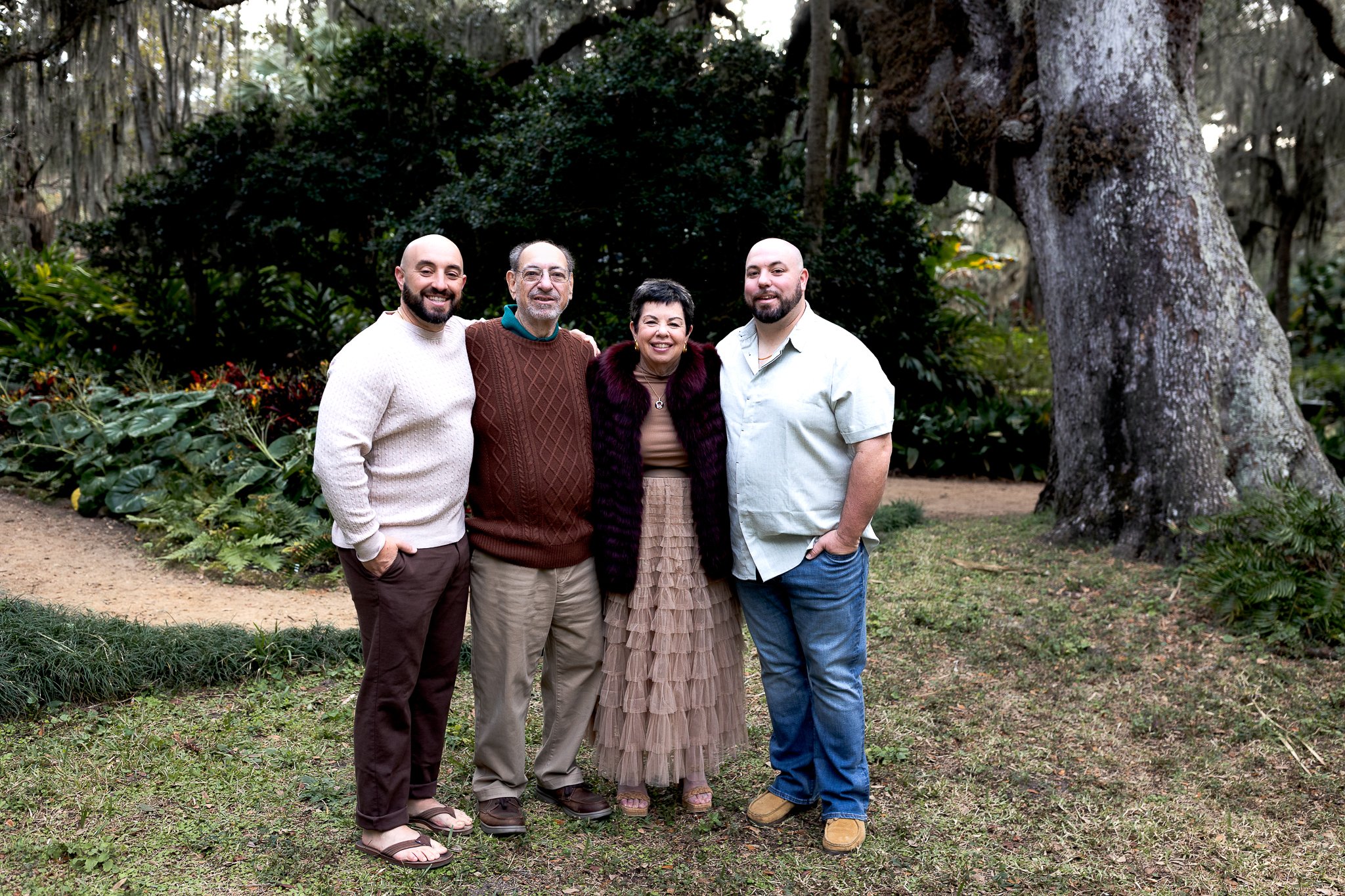 parents with adults sons under oak trees