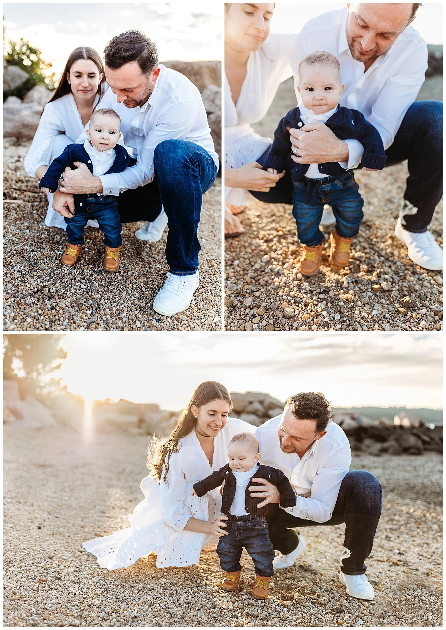 family kneeling on a rocky beach while helping six month old stand boy looking at camera smiling sunset n background laughing parents