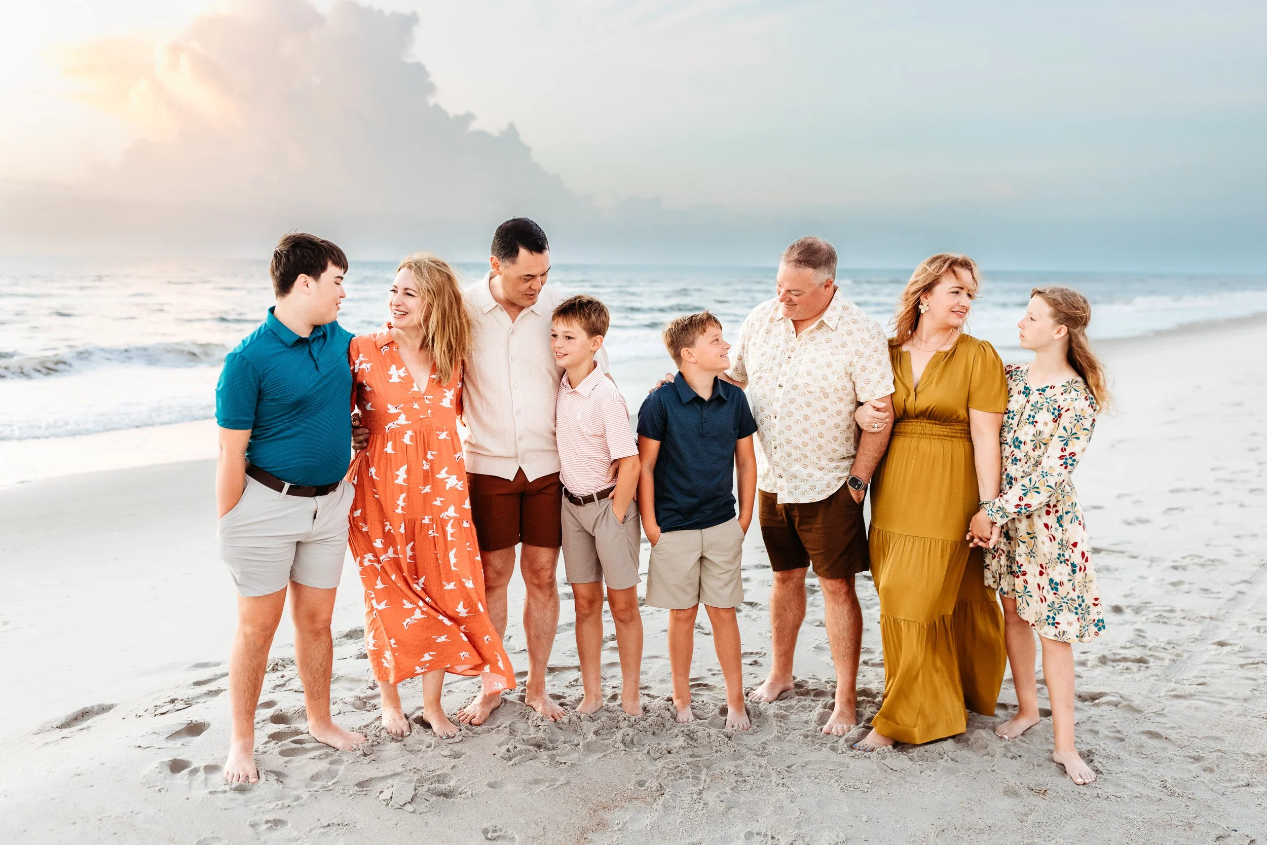 large group portrait of a family on the beach at sunrise