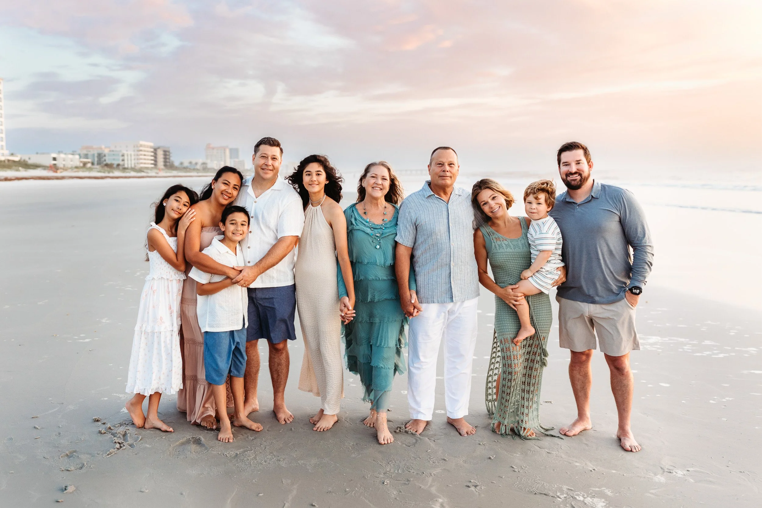 family on 11 south beach entrance in Jacksonville Beach for large group family portrait at sunrise