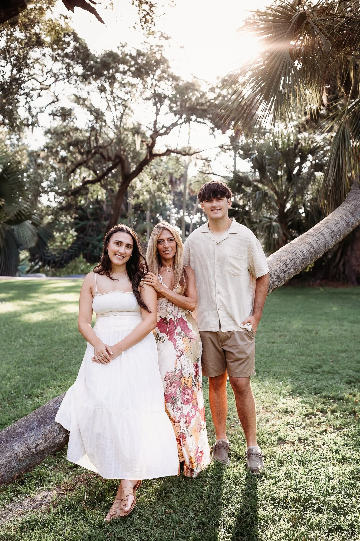 family seated on a curved palm at Johansen park for morning family photos