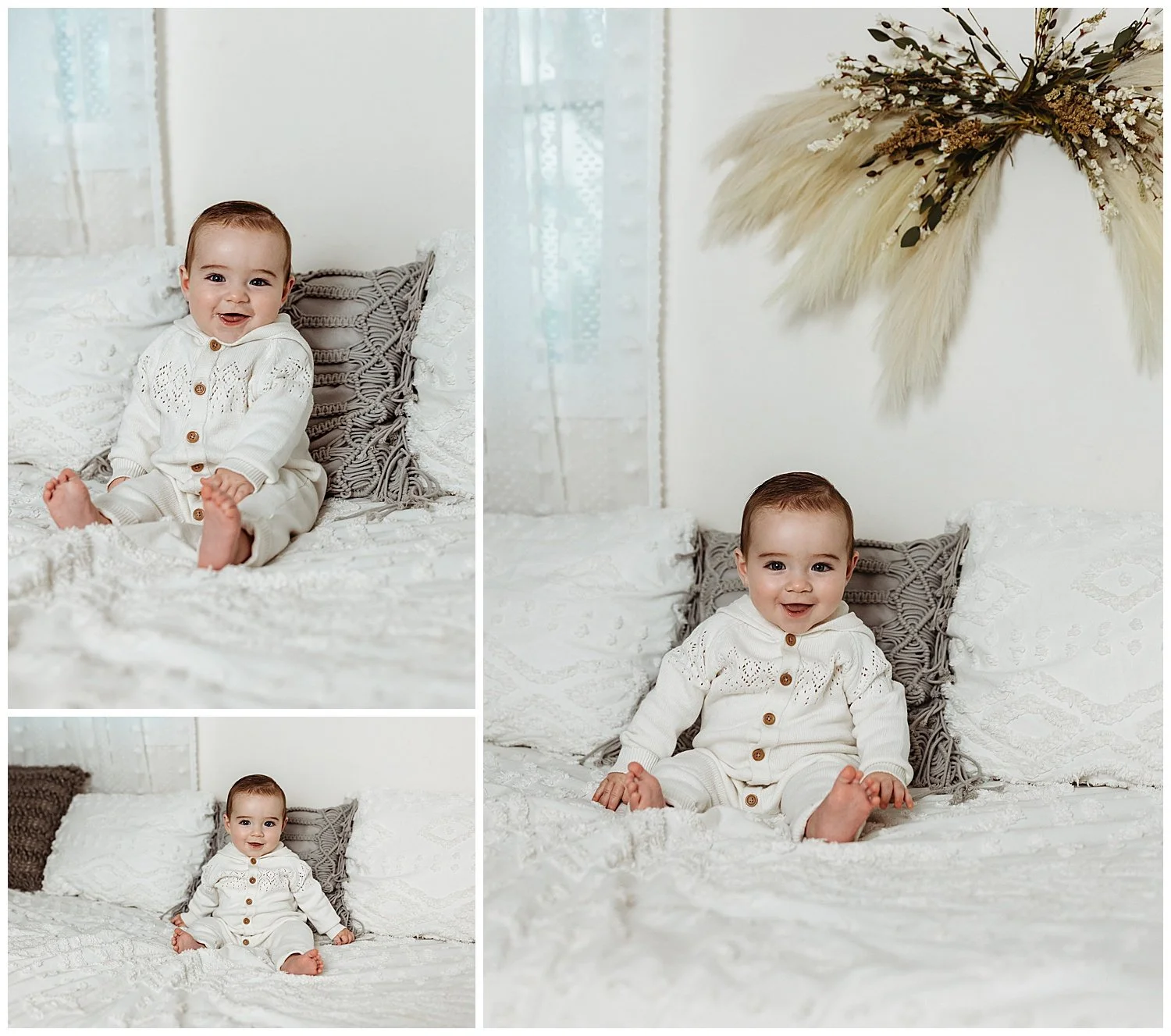 baby boy seated on ehite bed with grey pillows and pampas grass wreath laughing