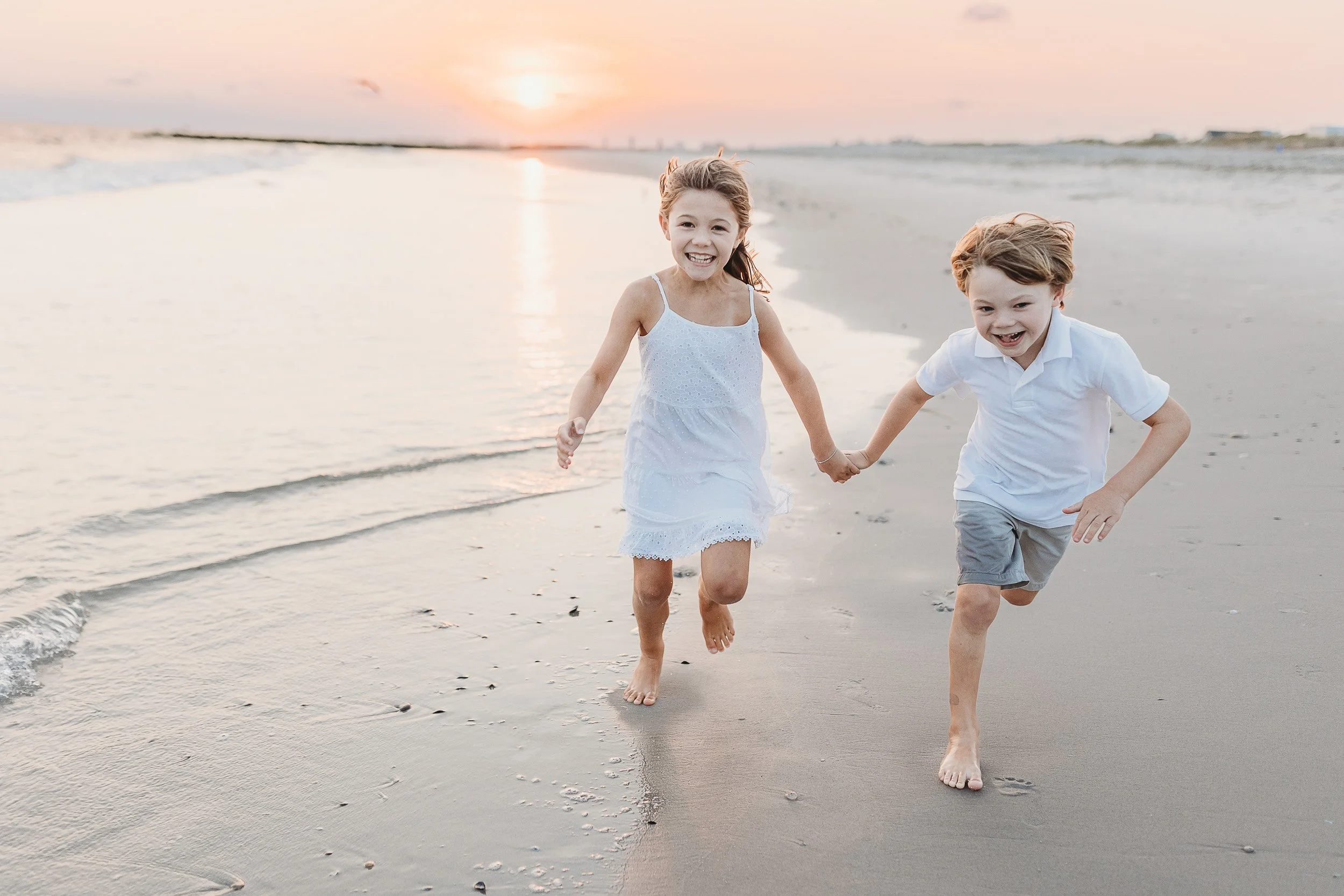 toddlers running on the beach at sunset in st augustine