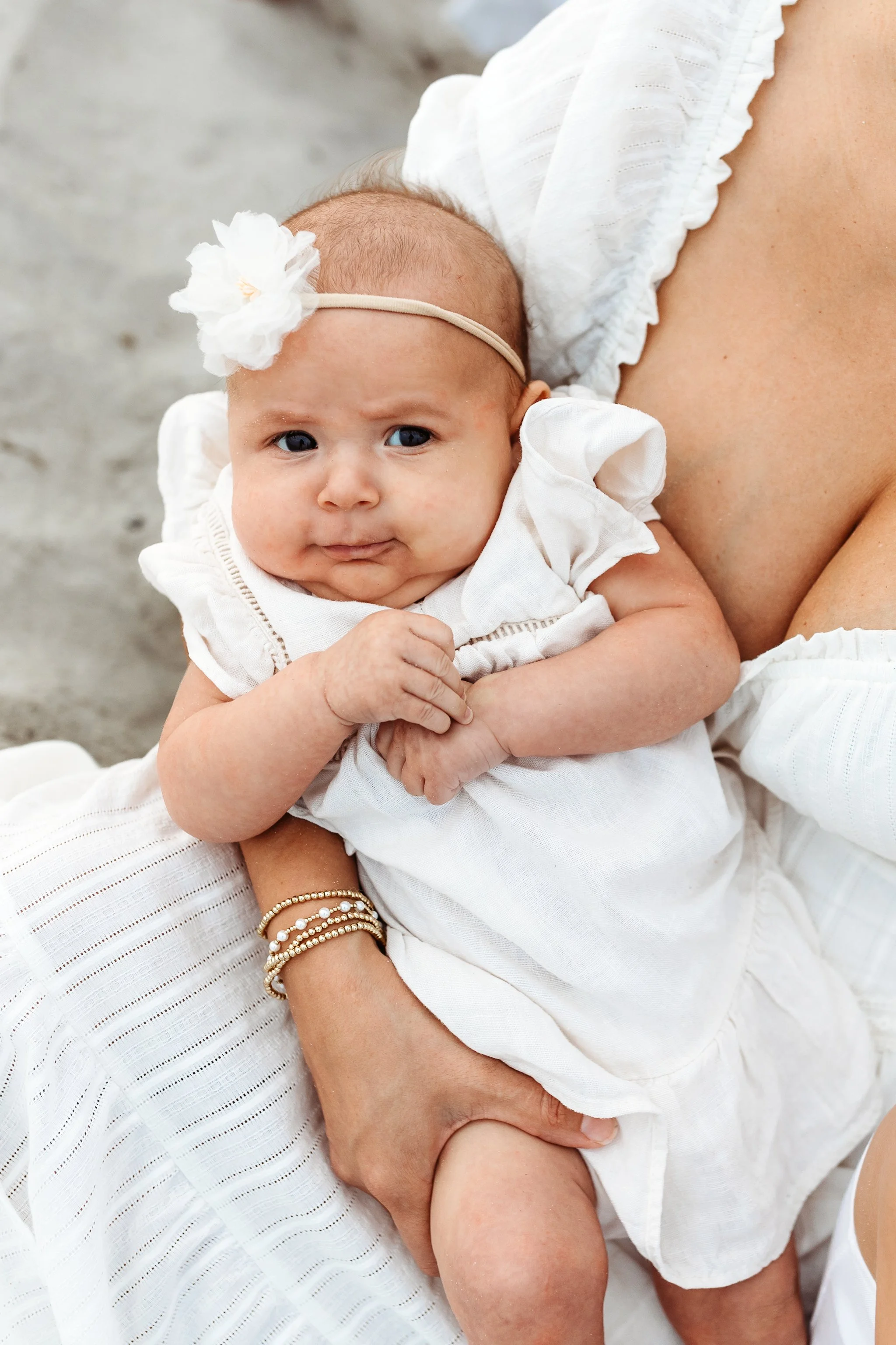 close up of baby in mom's arms