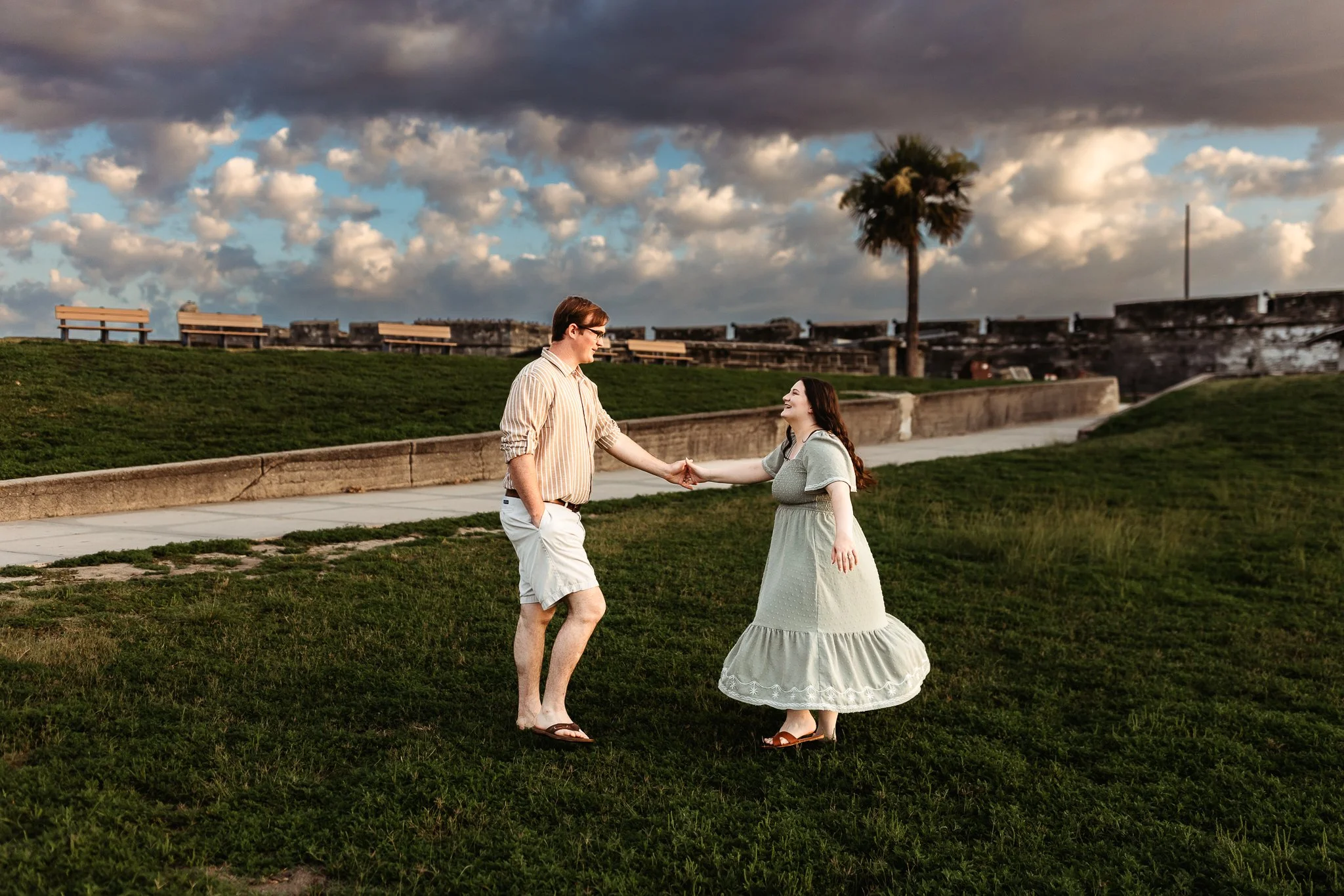 couple dancing on the lawn in front of the fort in st augustine for a photo session at sunrise