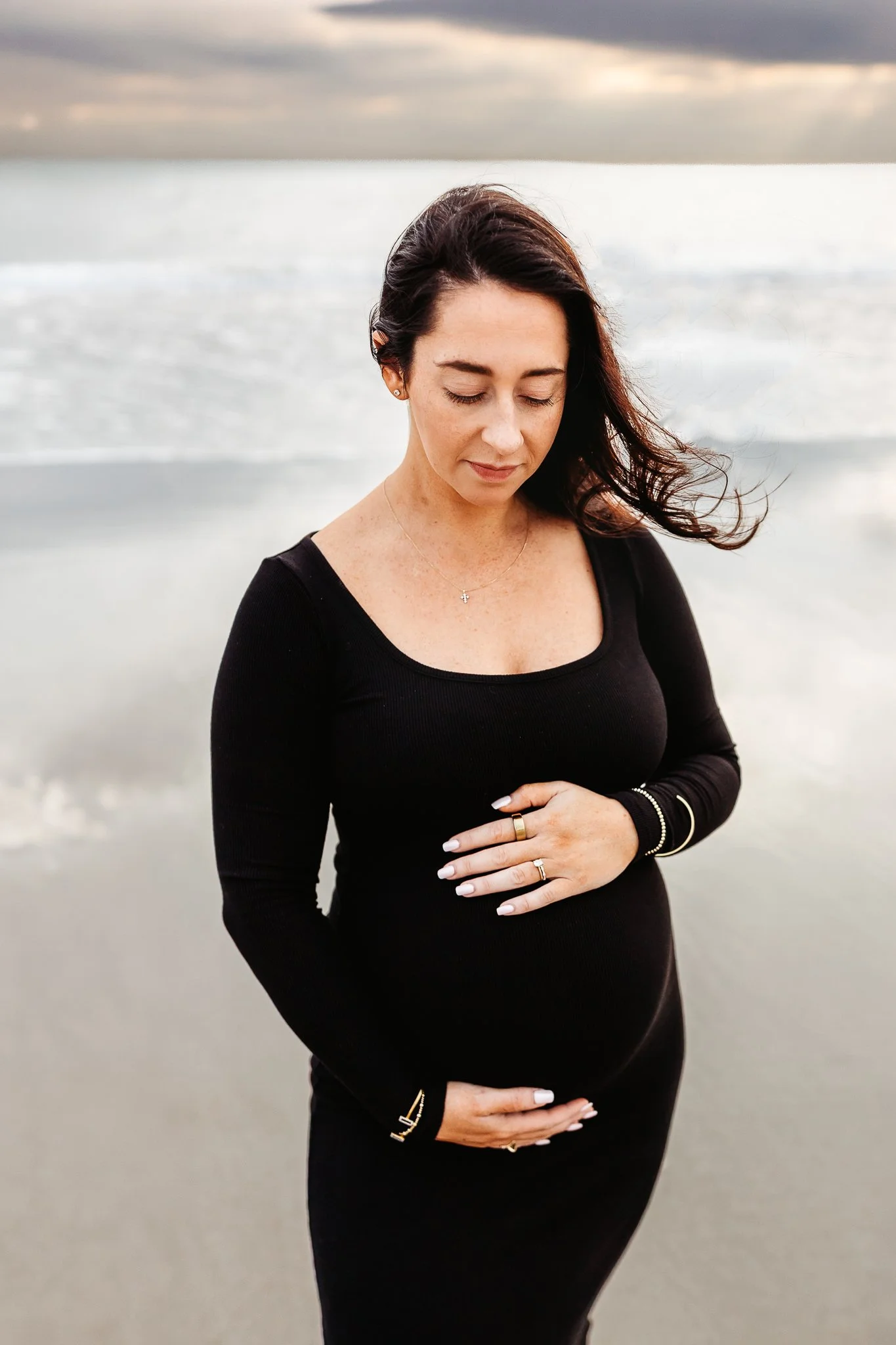 Solo maternity portrait of an expecting mother standing in the ocean in Ponte Vedra.
