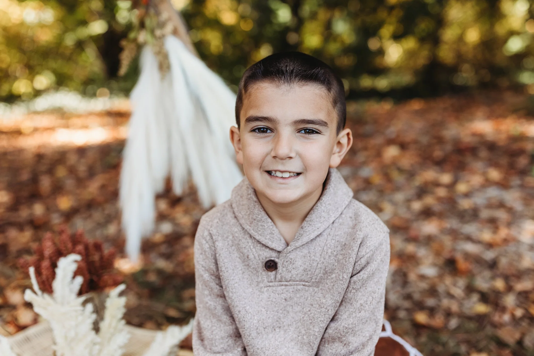 close up of boy in tan sweater