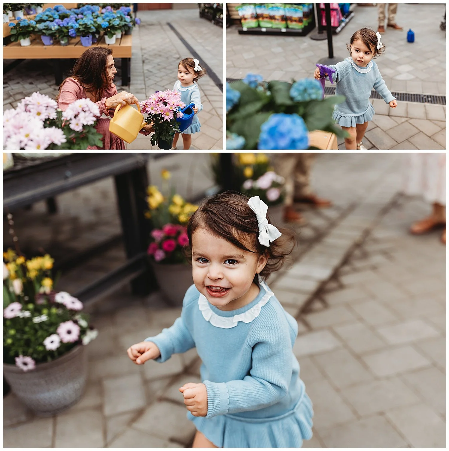 toddler girl in blue dress running in a nursery and waterign the flowers with her grandma who is wearing a pink maxi dress