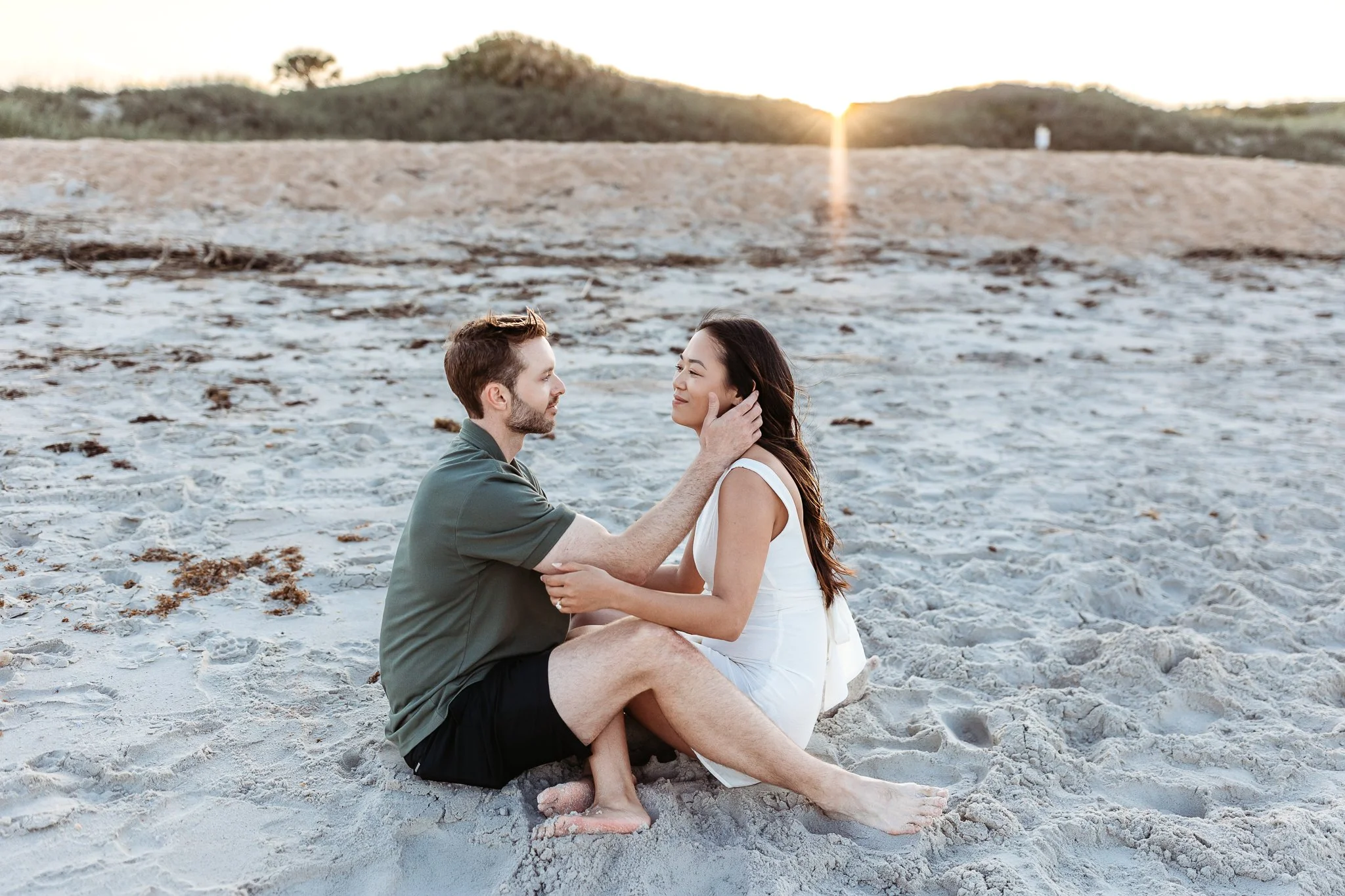 woman staring at each other while seated on the beach in Ponte Vedra after getting engaged