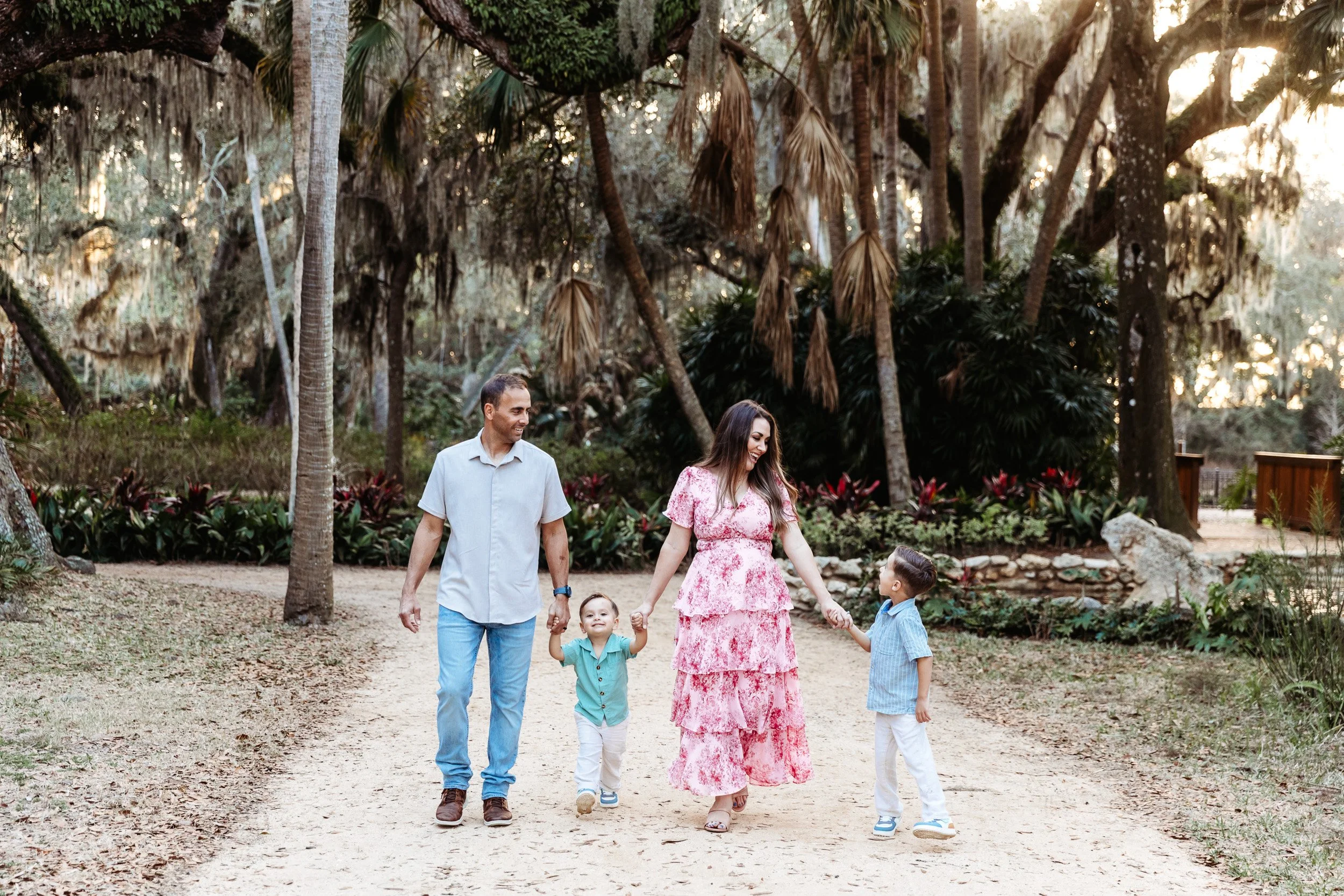 family walking in Washington oaks garden in the morning for family photos