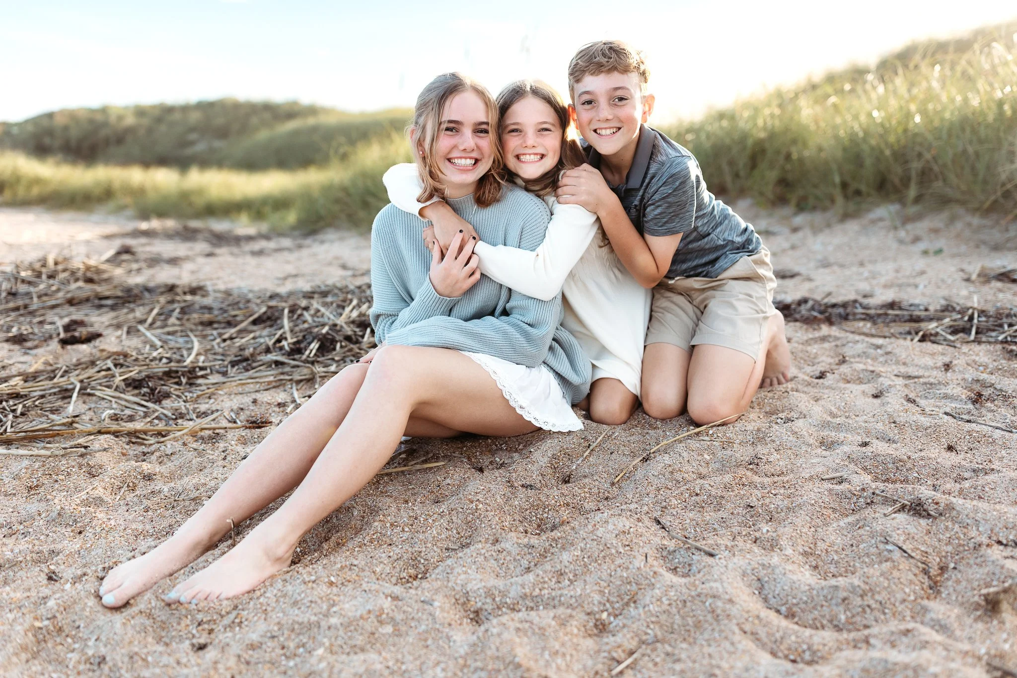 kids on the beach in st augustine in front of a dune