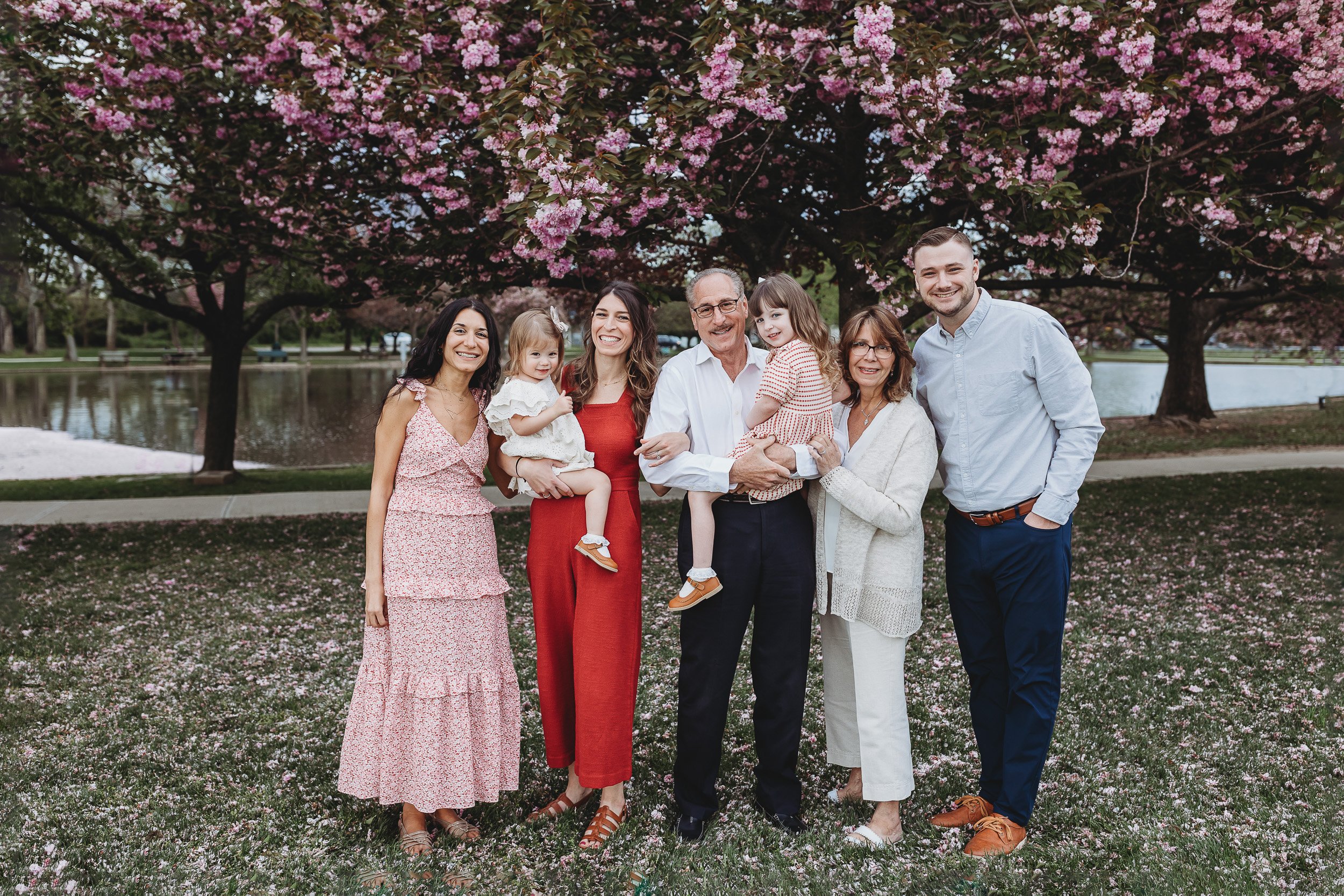 extended family portrait in front of cherry blossoms for spring family photos in Jacksonville