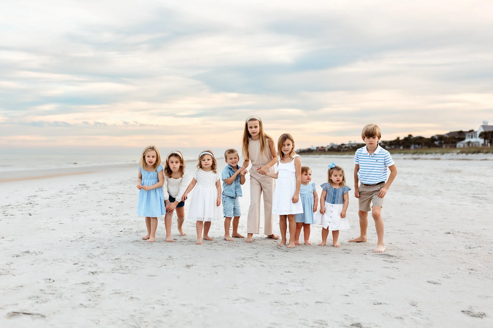 cousins running on the beach at sunset
