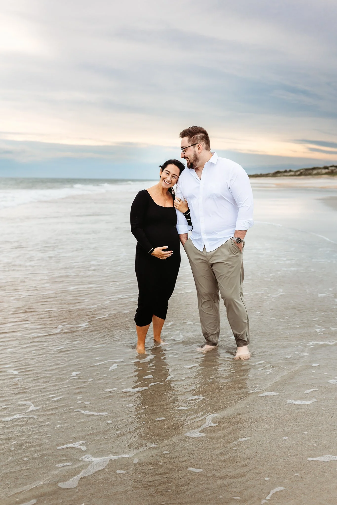 21.jpg	Expecting couple touching foreheads while embracing on the beach in Ponte Vedra.