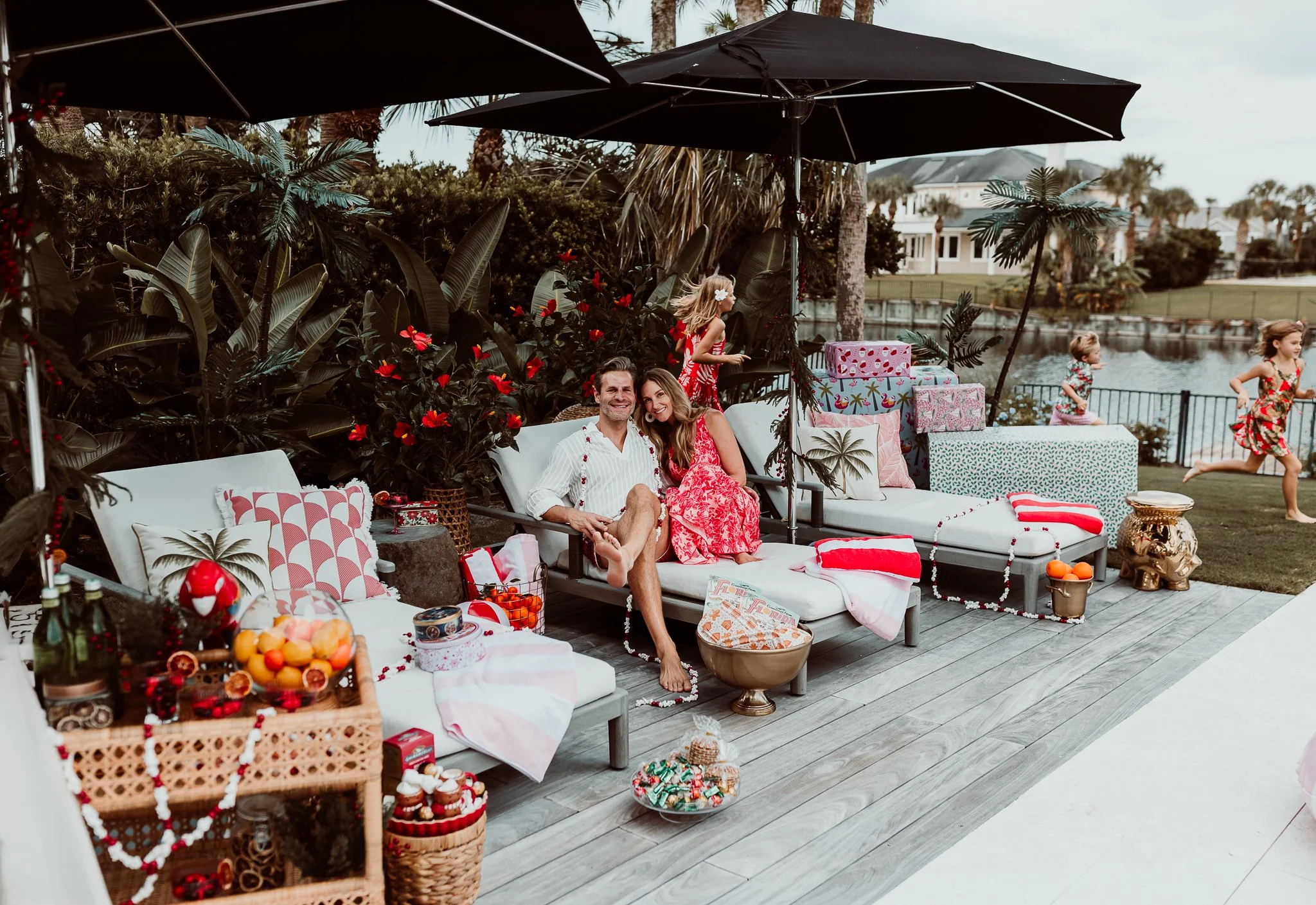 husband and wife state don a chaise lounge with petrol holiday decorations and their children are running behind them