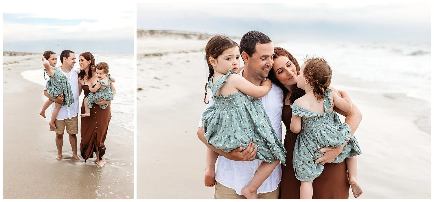 family in the ocean waves embraced and smiling at each other wearing earth tones and cloudy grey sky