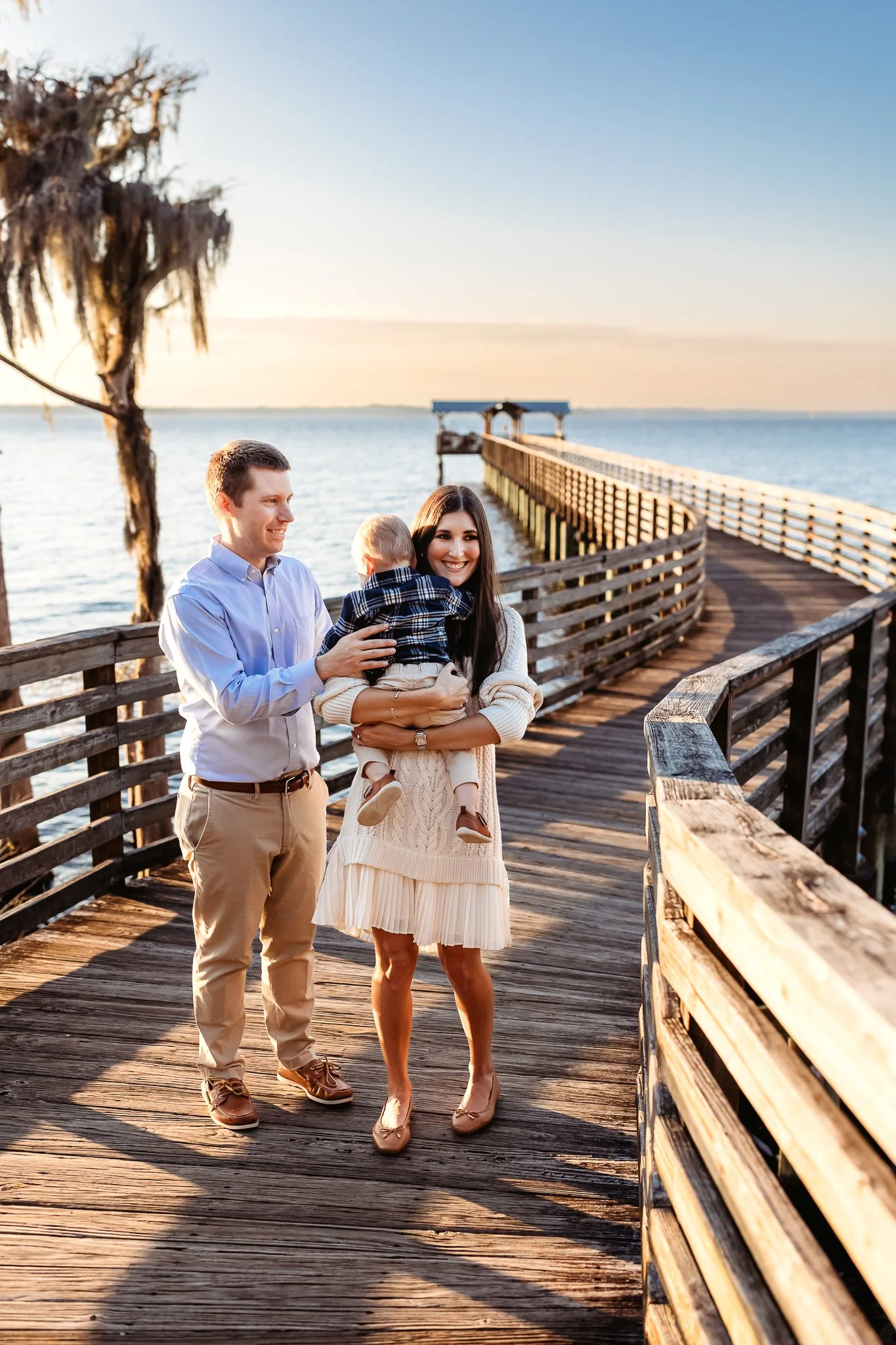 family walking on a pier at alpine groves park with a baby