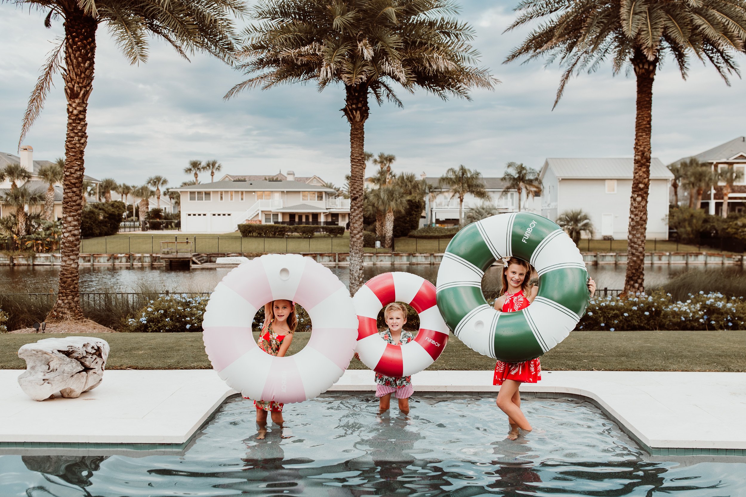 Children playing with oversized floats during a family photo session