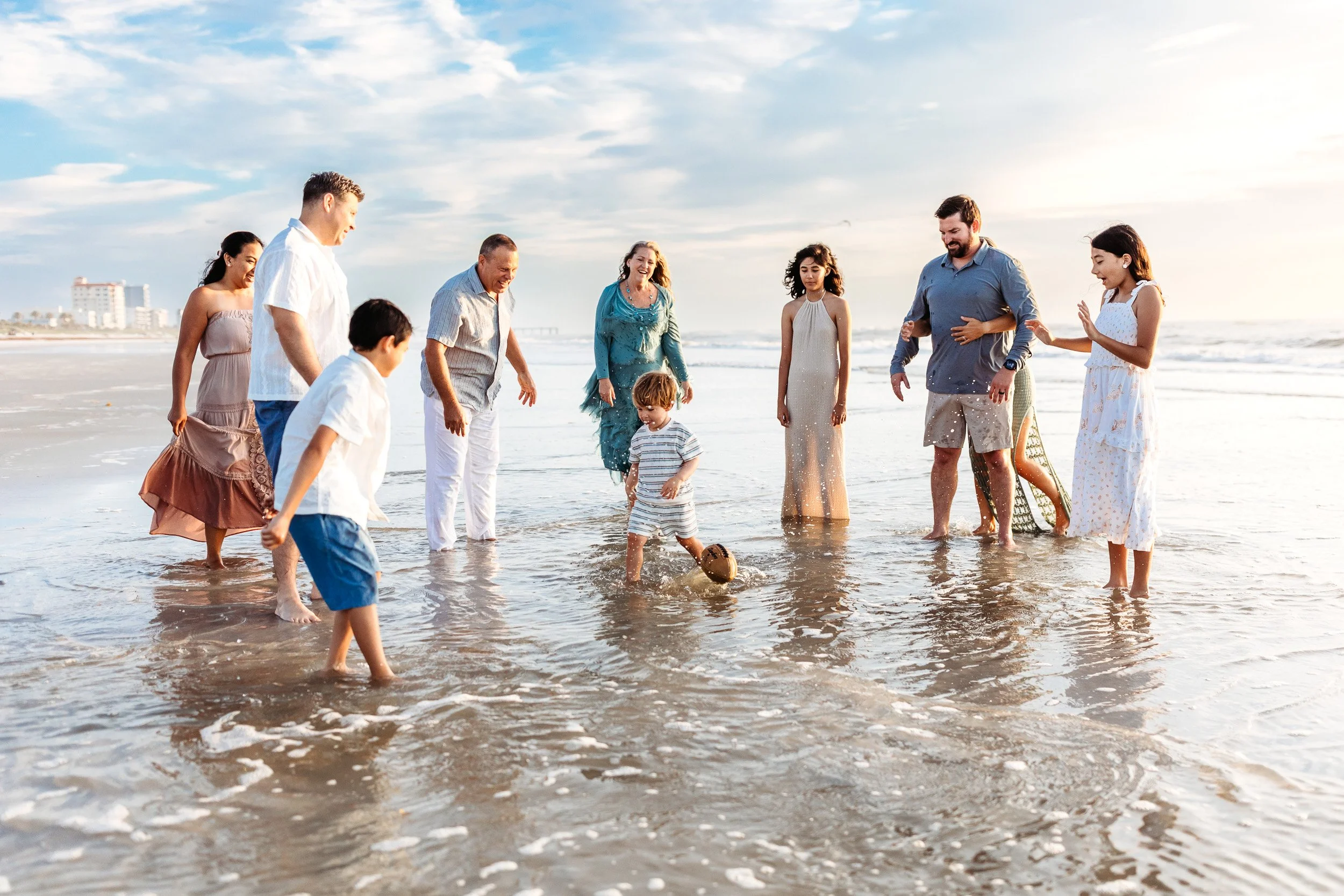family playing on the beach in Jacksonville at sunrise in a tide pool