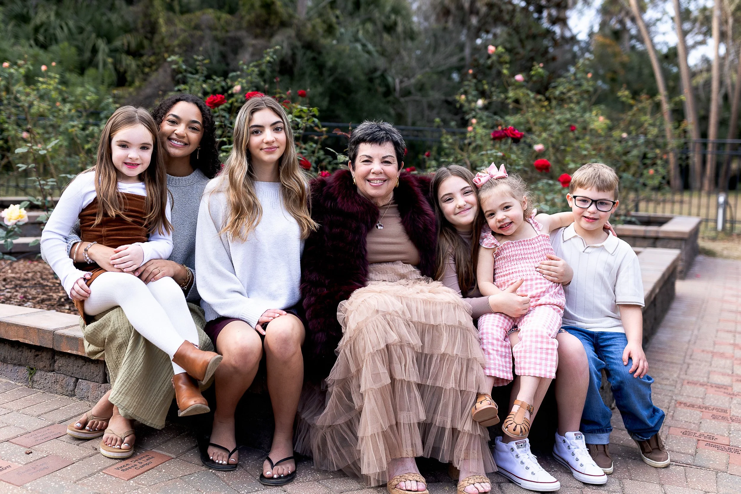 a grandma with all of her grandchildren in the rose garden at Washington oaks park in Palm Coast