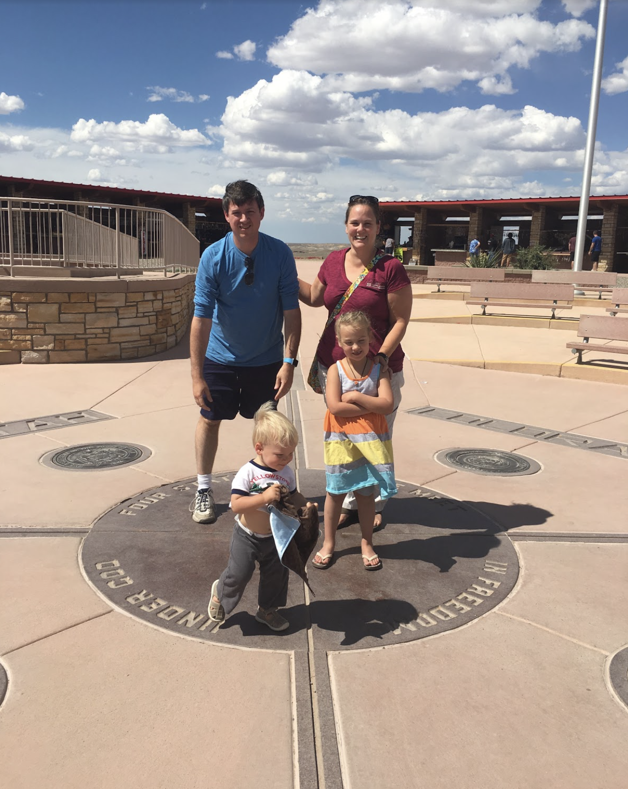 Here’s our family photo with each of us in a different state - You can see most of “UTAH” and “COLORADO” on the ground behind us.&nbsp; Popcorn preferred to run through the states over posing for a picture. Photo by kind stranger, 5/30/16
