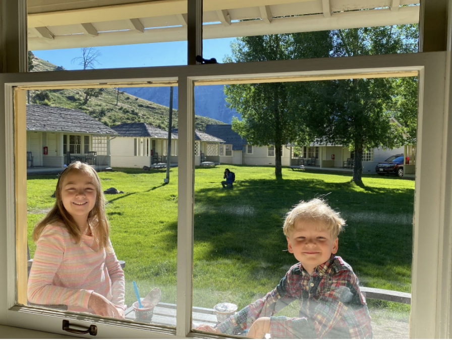 The kiddos eating breakfast on the front porch of our cabin at Mammoth Hot Springs. Photo by Karen Boudreaux, June 20, 2020