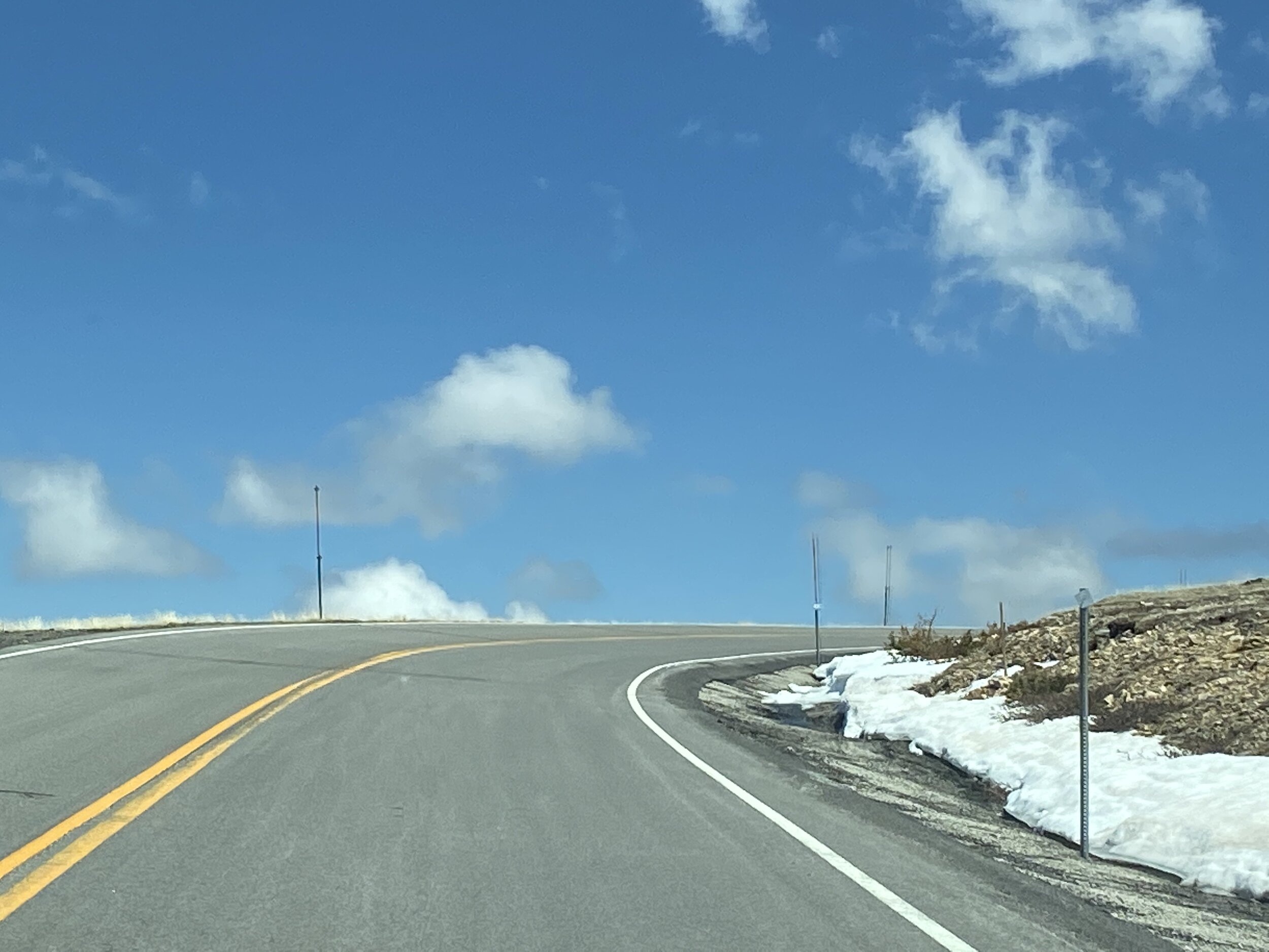 Nothing like the thrill of driving up into the clouds with steep dropoffs of thousands of feet down into the mountains on Beartooth Pass!  Photo by Karen Boudreaux, May 29, 2021