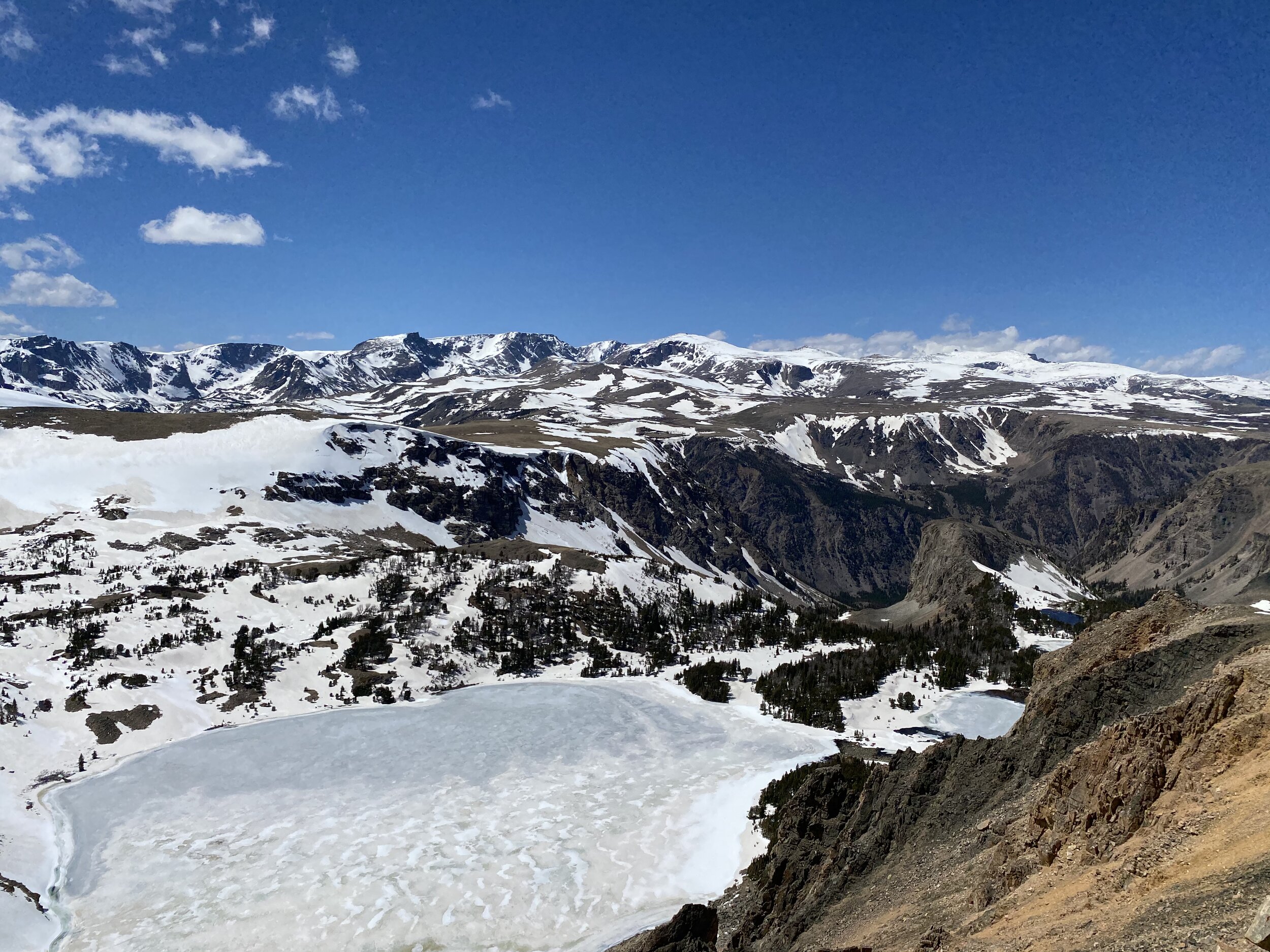 On Beartooth Pass, if you have the courage to look over the steep edges at some parts of the drive, you may discover a beautiful frozen lake amidst the gorgeous and expansive mountain view.  Photo by Karen Boudreaux, May 29, 2021