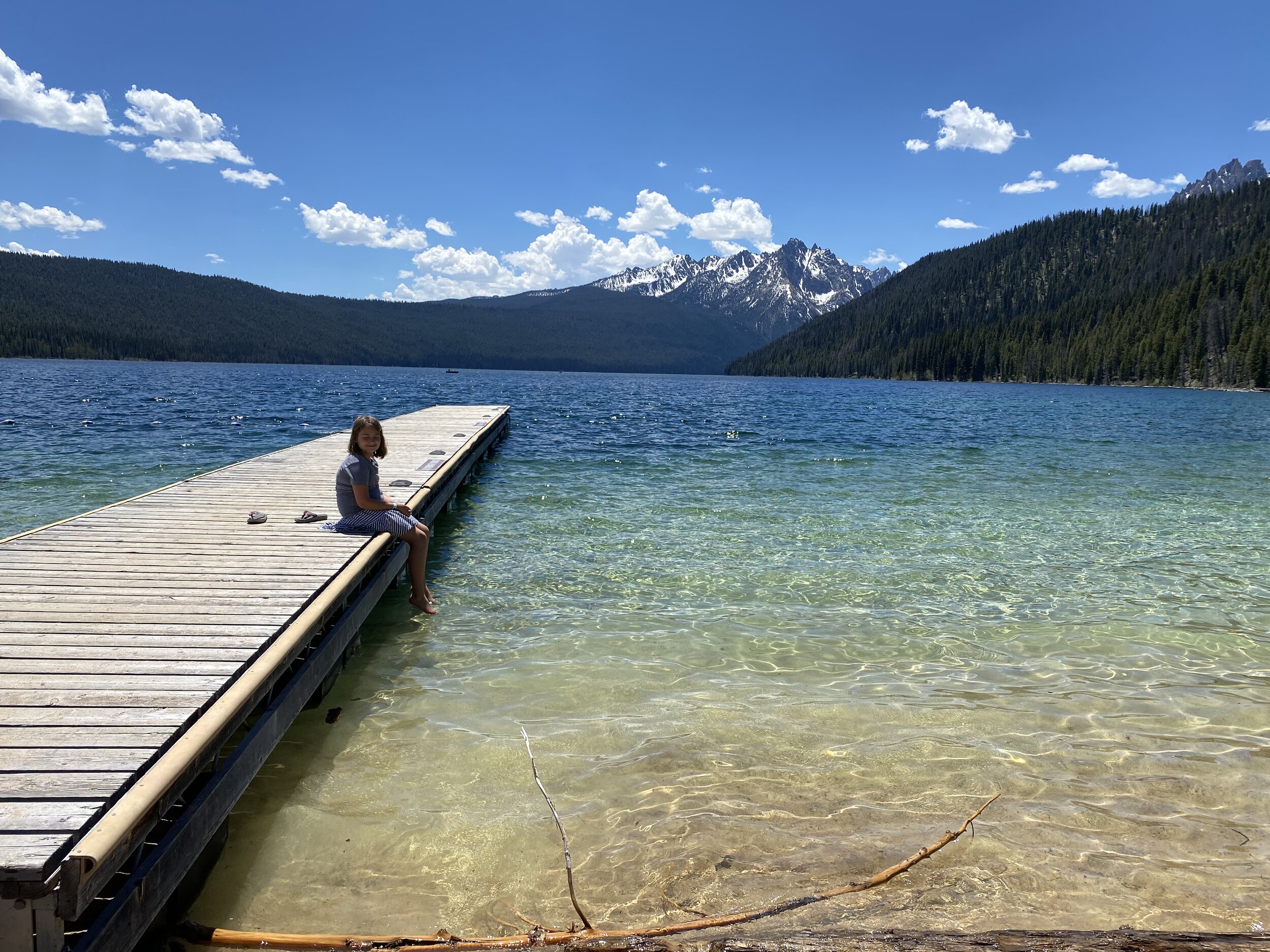 Bunny dips her toes in the crystal clear waters of Redfish Lake.  Photo by Karen Boudreaux, June 3, 2021