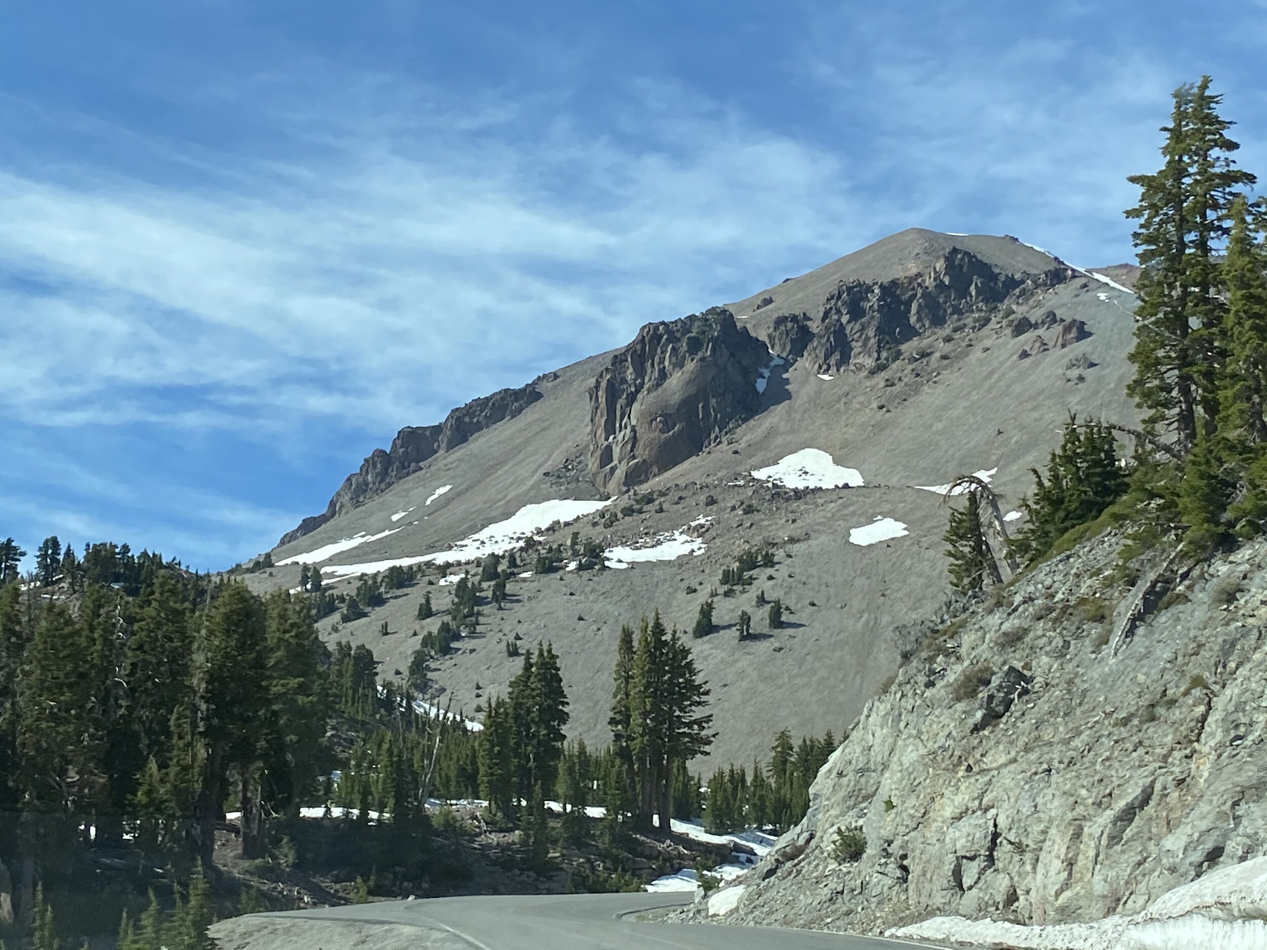 “If you look toward the south face of Lassen Peak, near the top, you will see a steep-sided, jagged, castle-like lava formation made up of pines of silica-rich dacite lava.  This feature is almost 500 feet tall and 500 feet wide.  Look closer.  Weathering on the rock face resembles an eye.  Some call it Vulcan’s Eye, after Vulcan, the Roman god of fire after whom volcanoes are named.” - Visitor’s Center display.  Photo by Karen Boudreaux, June 5, 2021