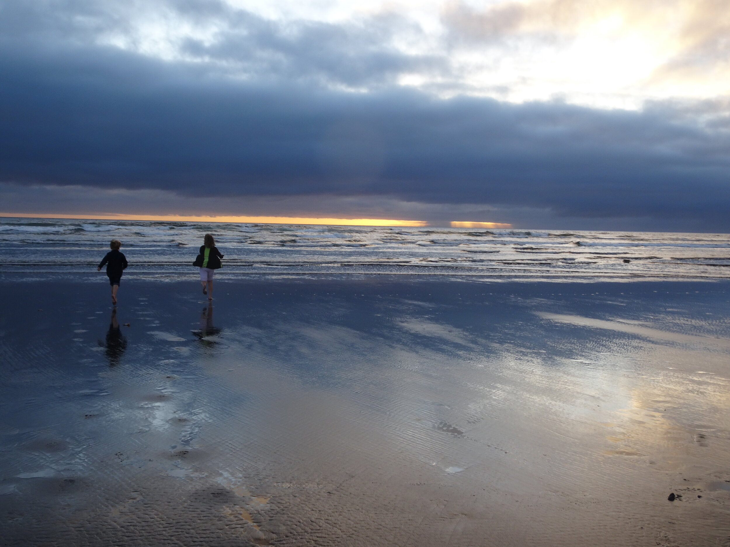 The kids race to the ocean in Seaside, OR.  Photo by Karen Boudreaux, June 14, 2021