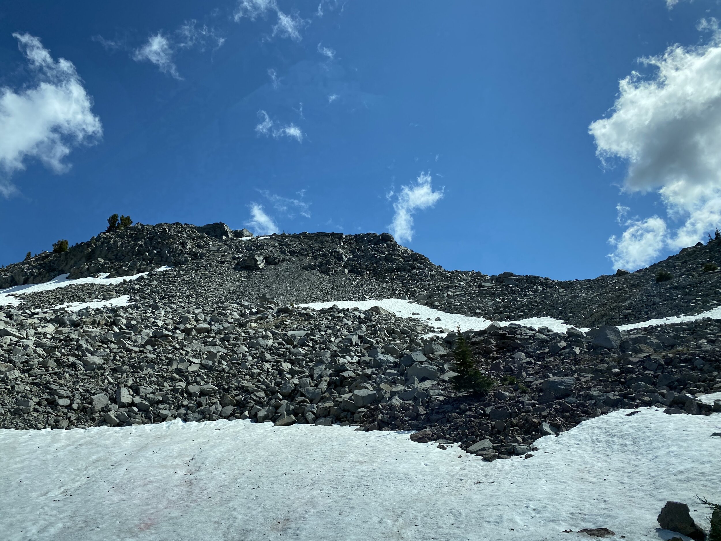 The contrast of black volcanic rocks with the white snow that has a number of these trails still closed.  Photo by Karen Boudreaux, June 8, 2021