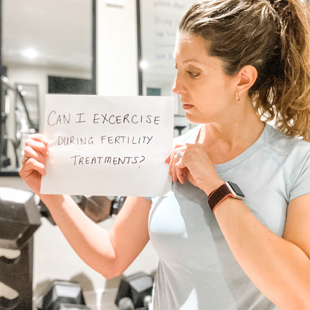 woman holding a sign that reads &quot;can i exercise during fertility treatments&quot;