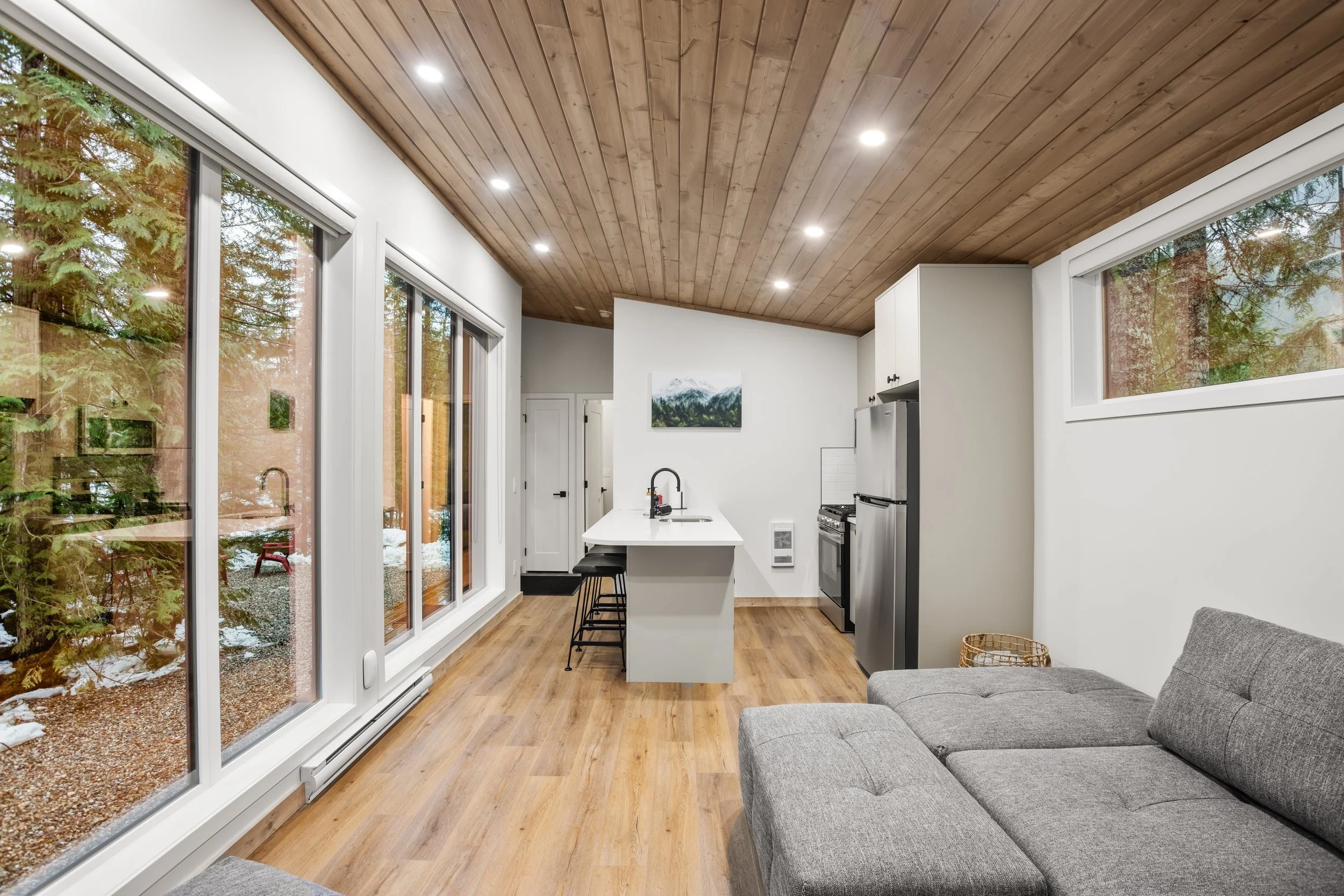 Shuswap open living room and kitchen with a sofa and a sliding glass door