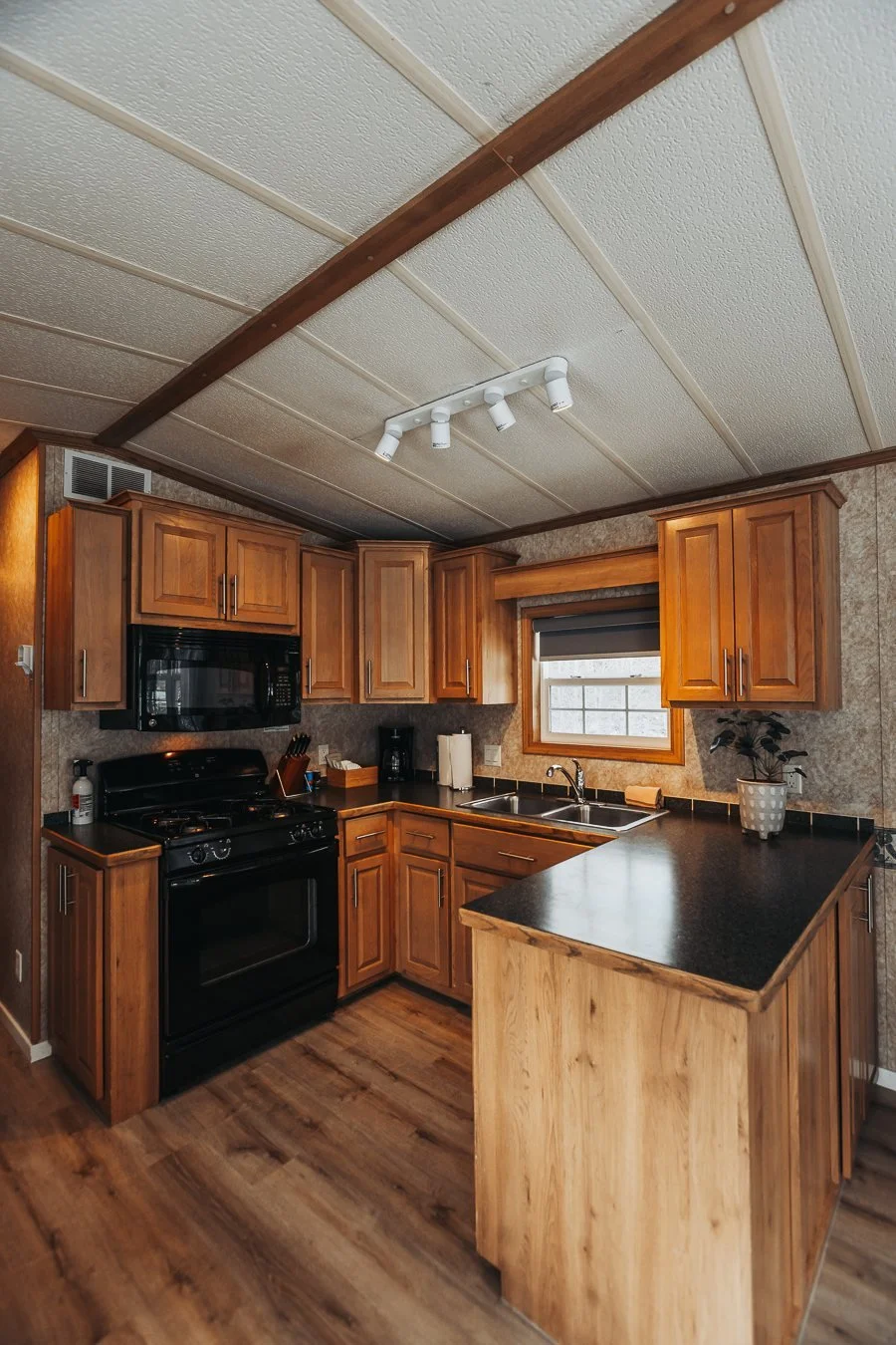Hatchery Cabin 5 kitchen with wood cabinets and a small island