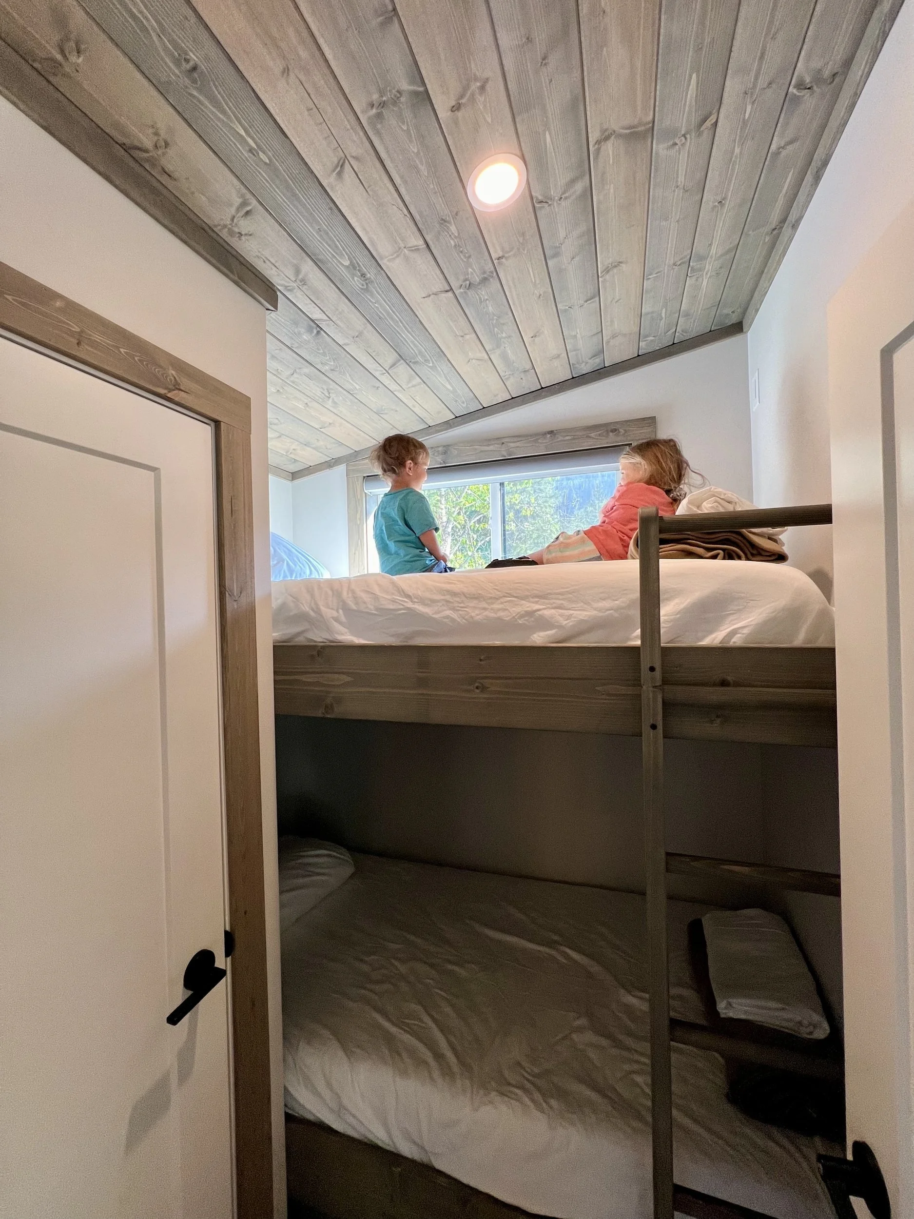 Two kids on the bunk beds in the optional Monashee bunk room
