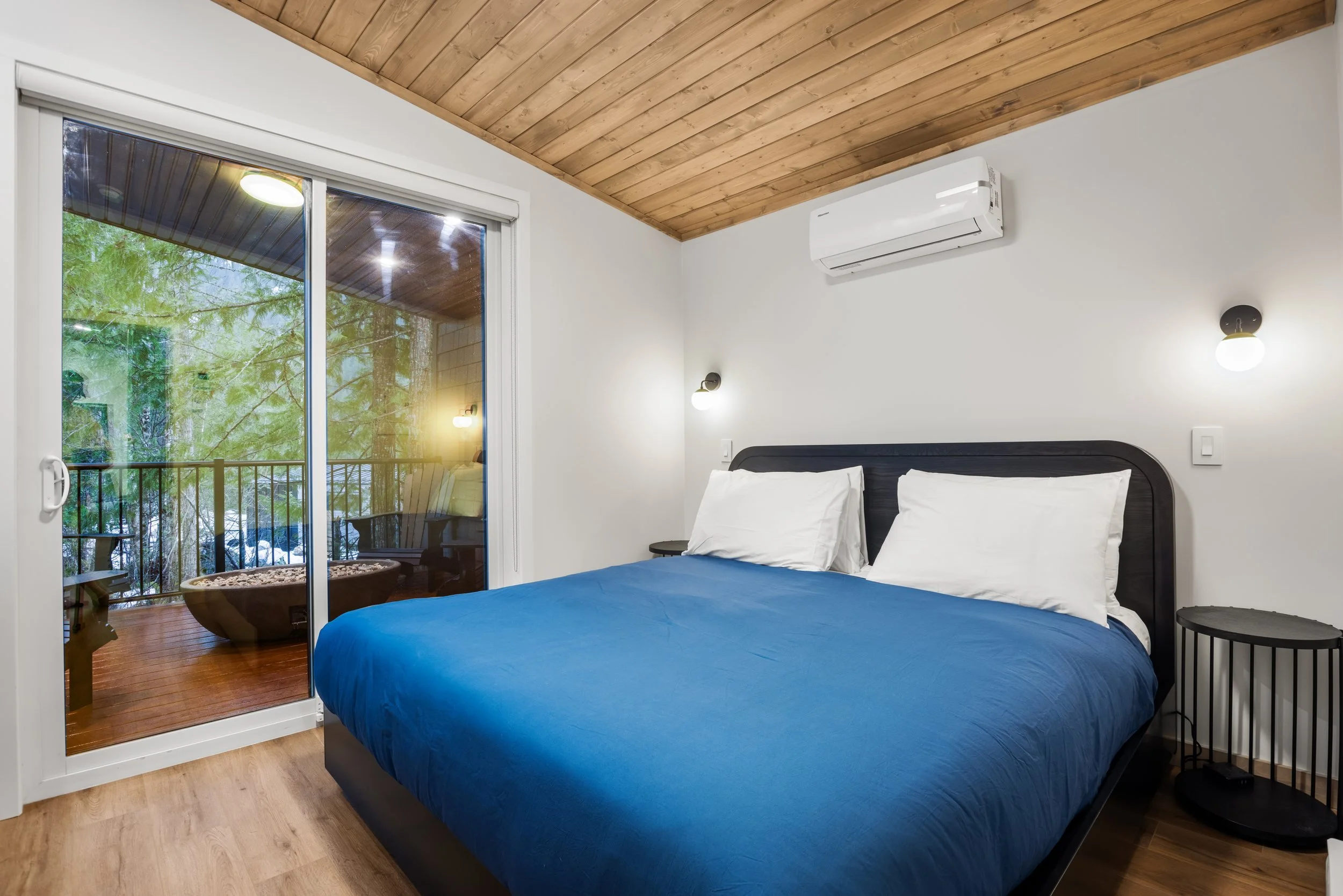 Shuswap king bedroom with a sliding glass door onto the covered deck