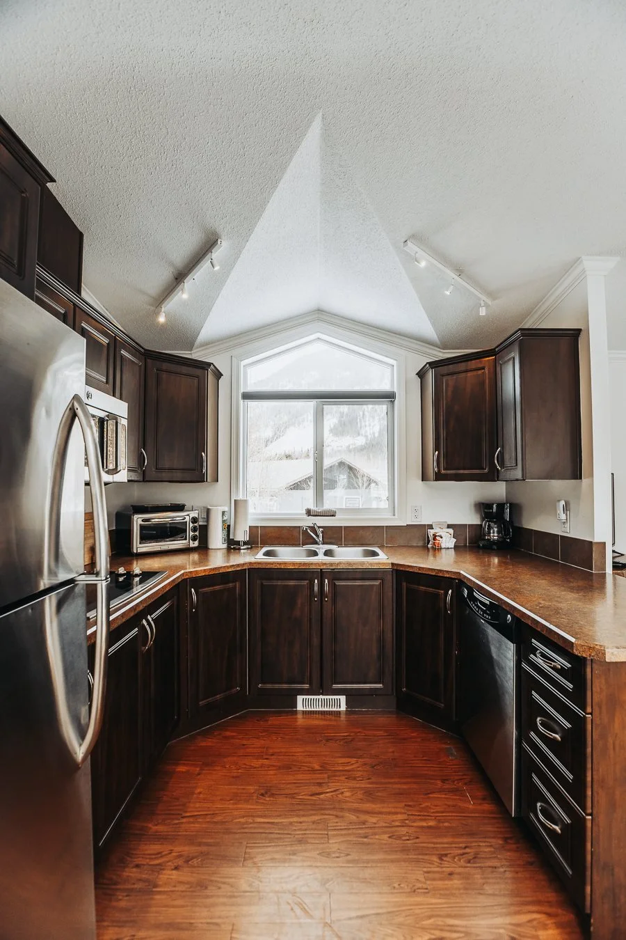 Hatchery Cabin 6 kitchen with dark cabinets and stainless steel appliances