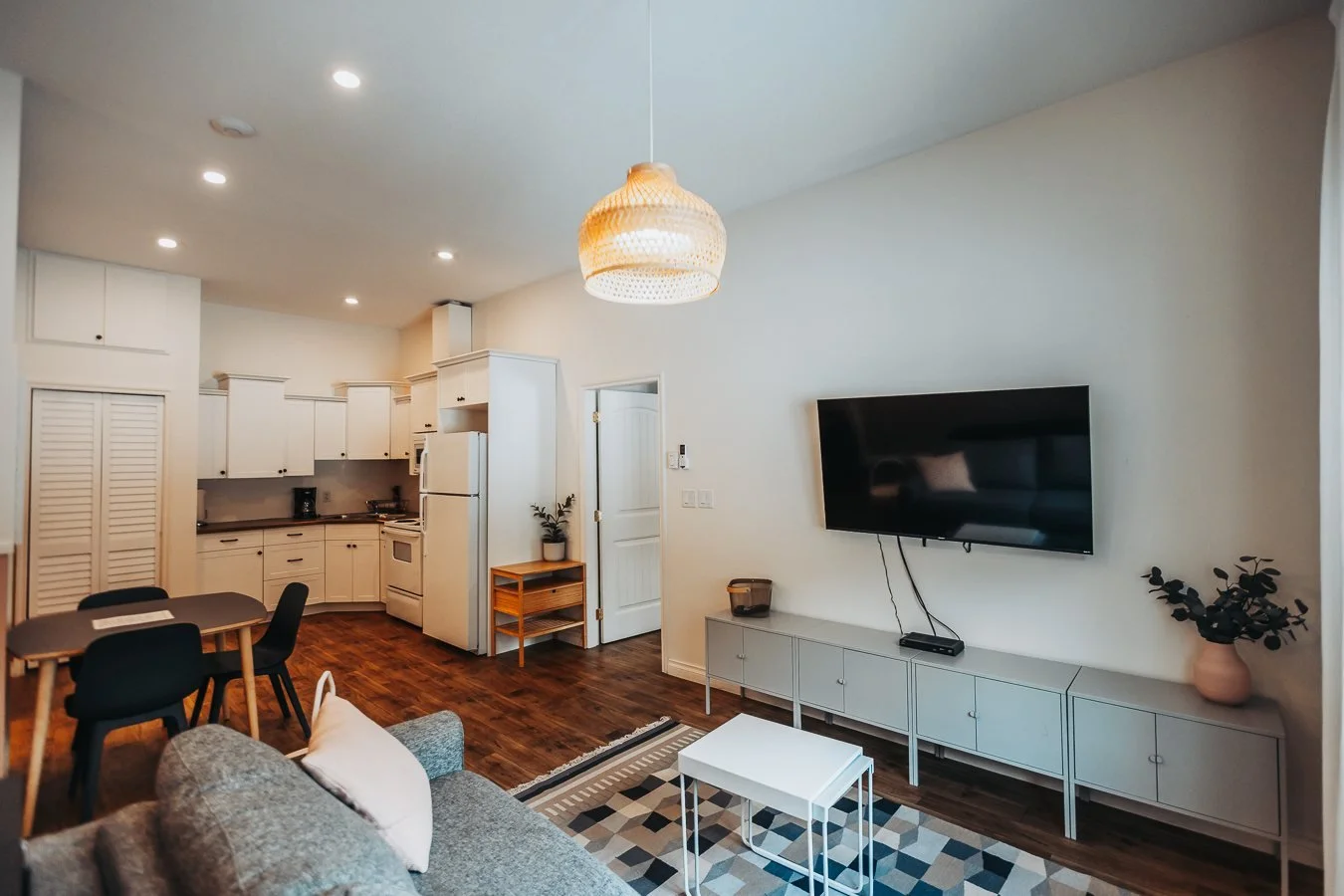 Hatchery suite living room with a sofa, a TV and a dining table