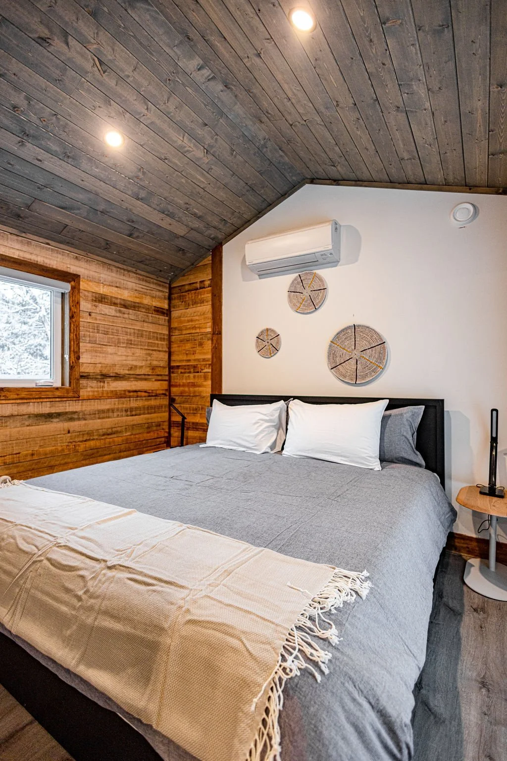 Apex king bedroom with a wood-panelled accent wall