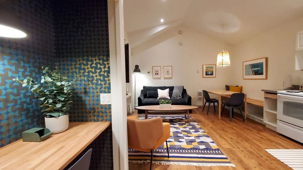 Hatchery suite living area and kitchen with a patterned rug