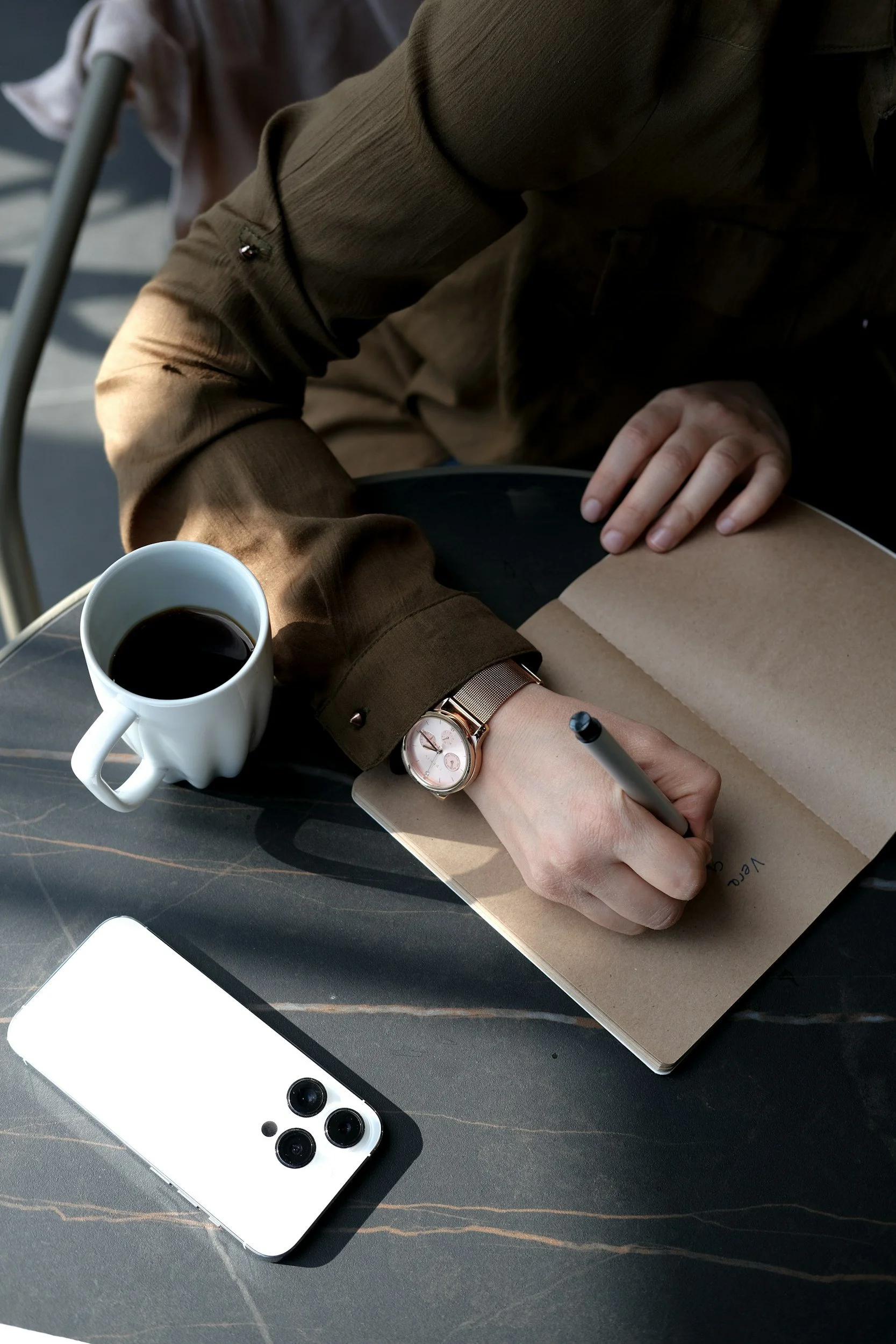 A journal and coffee in soft morning light, suggesting the small daily practice of change.