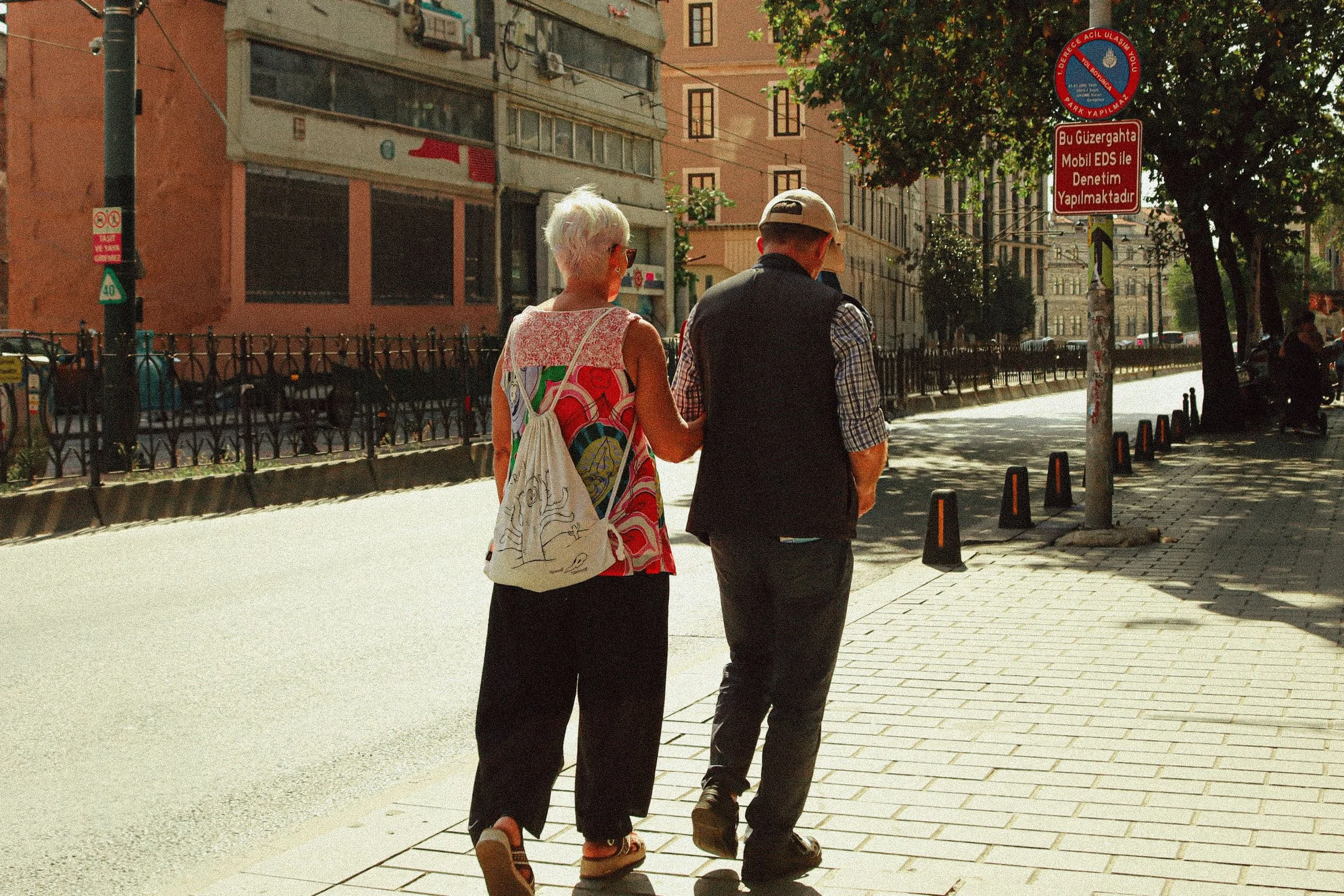 Long-together couple holding hands on a walk, the payoff of tending a good thing