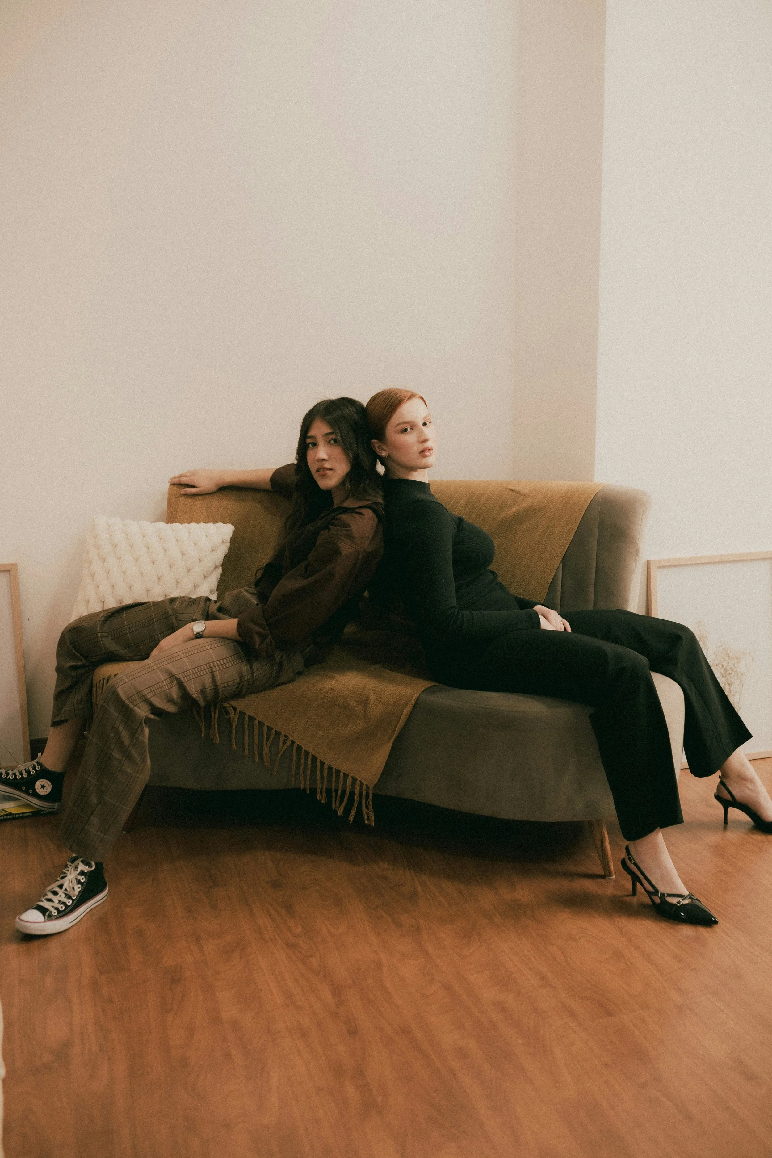 Couple on couch facing away from each other, feeling disconnected from partner