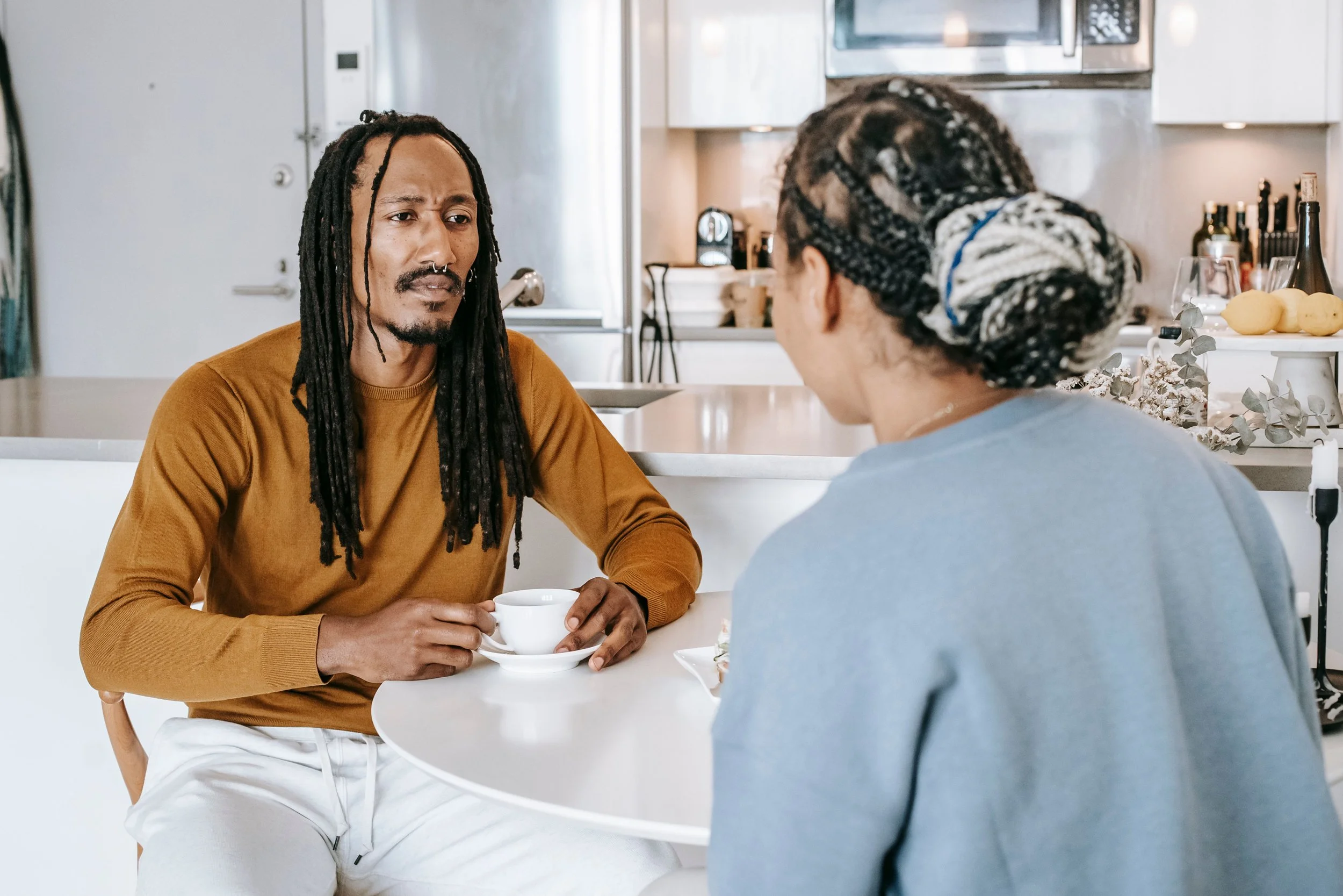 Couple talking over morning coffee, relationship maintenance as a weekly habit