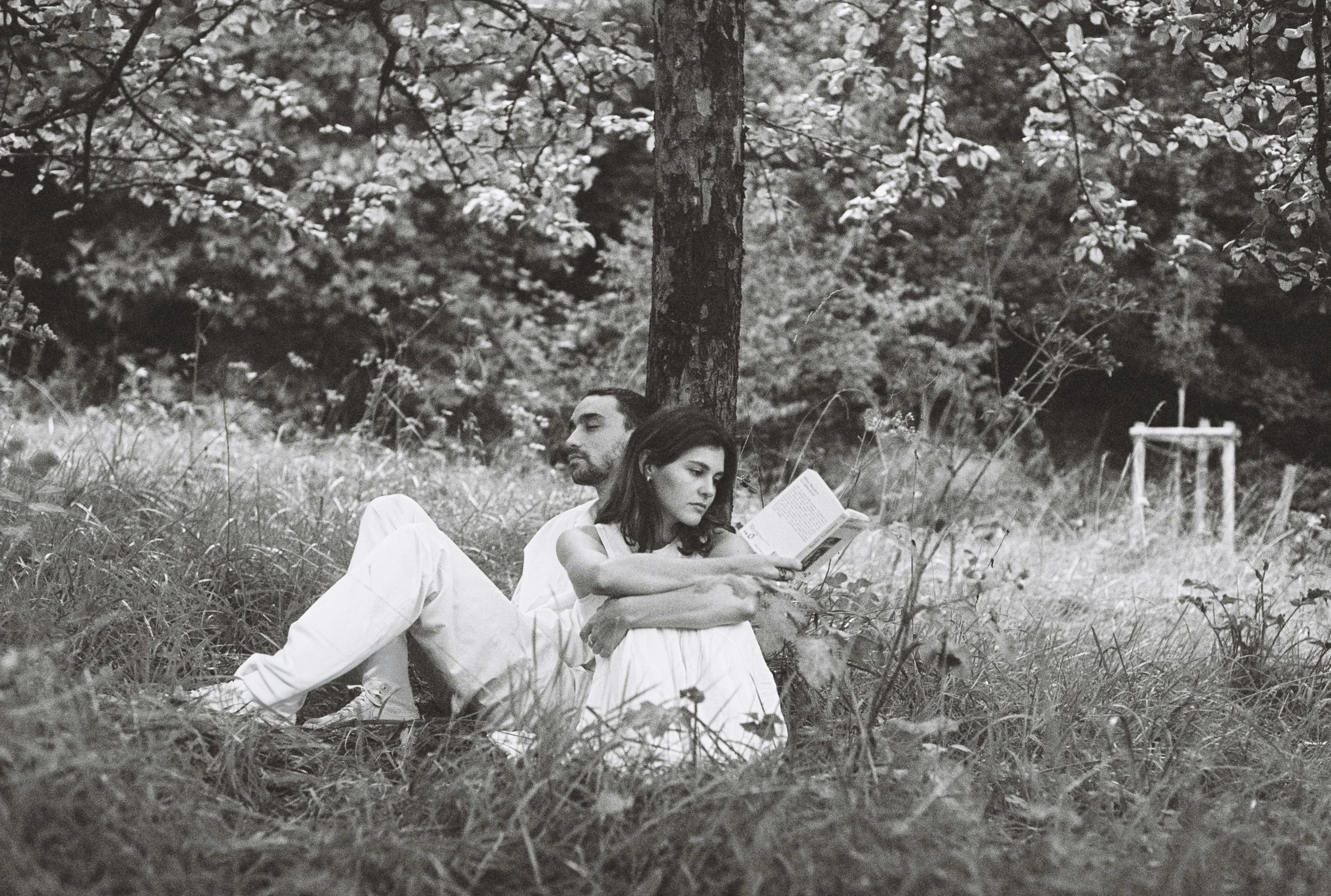 Couple sitting quietly in a field feeling lonely in their relationship