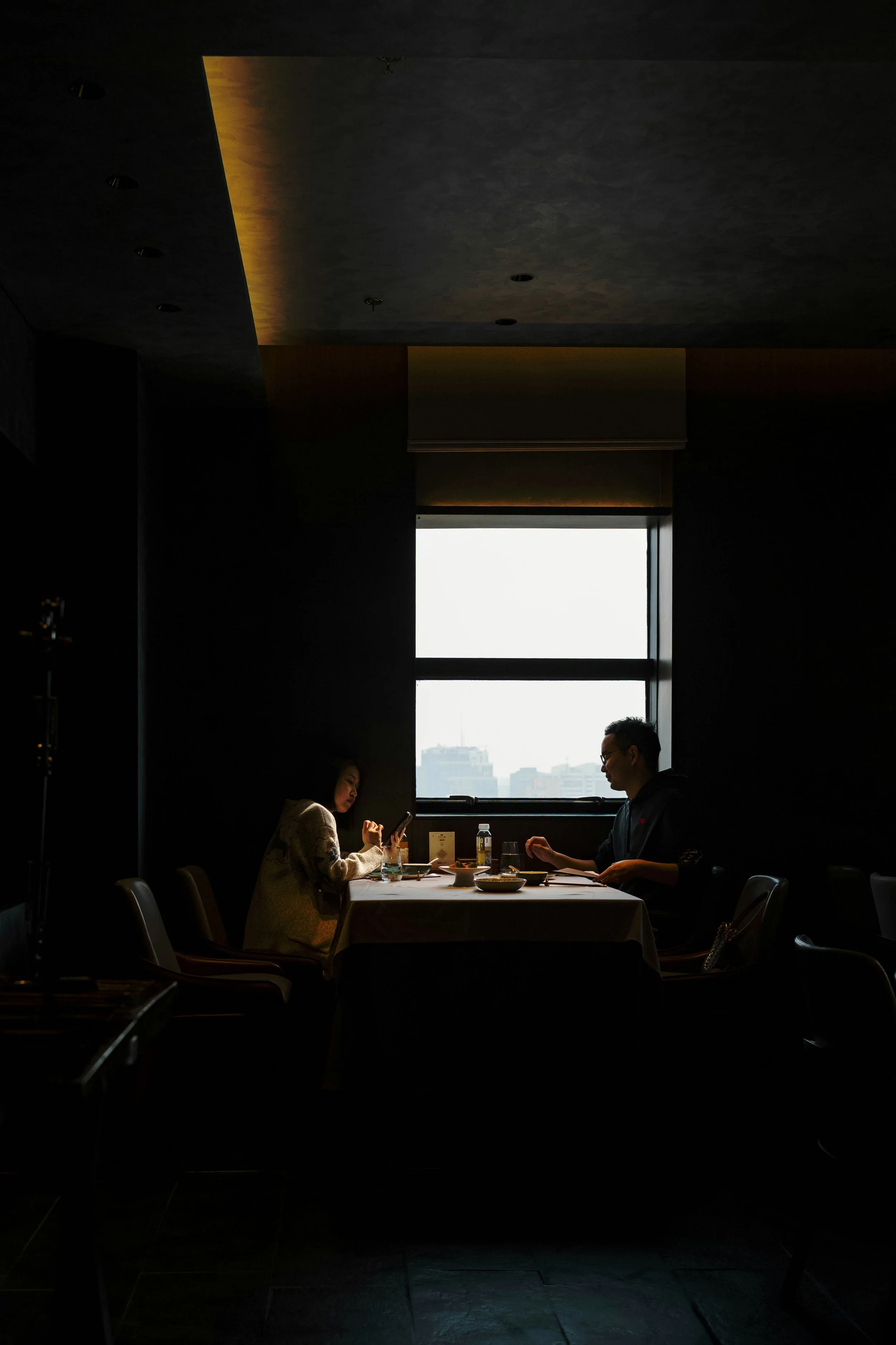 Couple at table feeling lonely in relationship avoiding conversation
