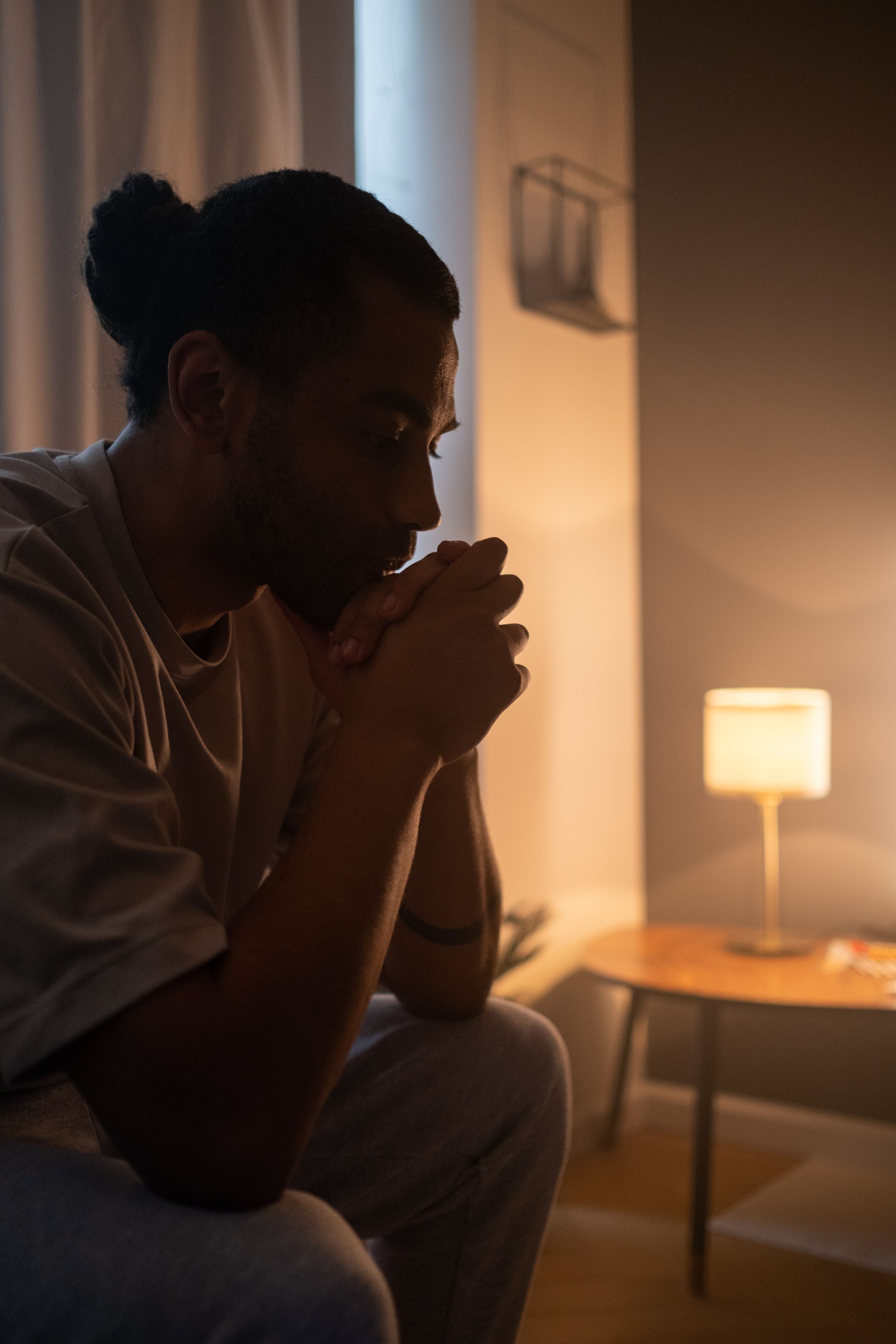 Adult sitting quietly at home, the difference between depression and sadness